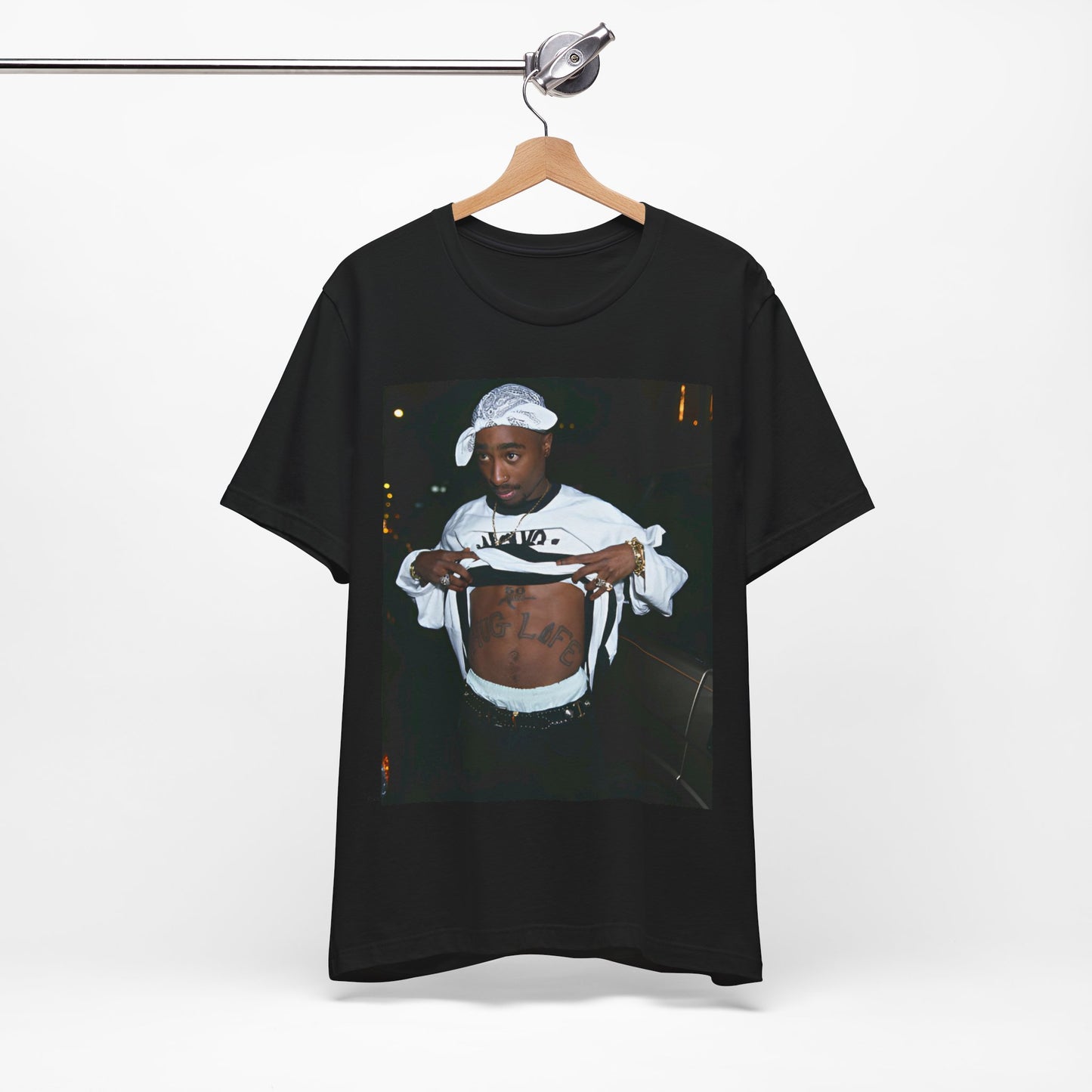A black graphic t-shirt featuring a graphic of Tupac Shakur (2Pac).
