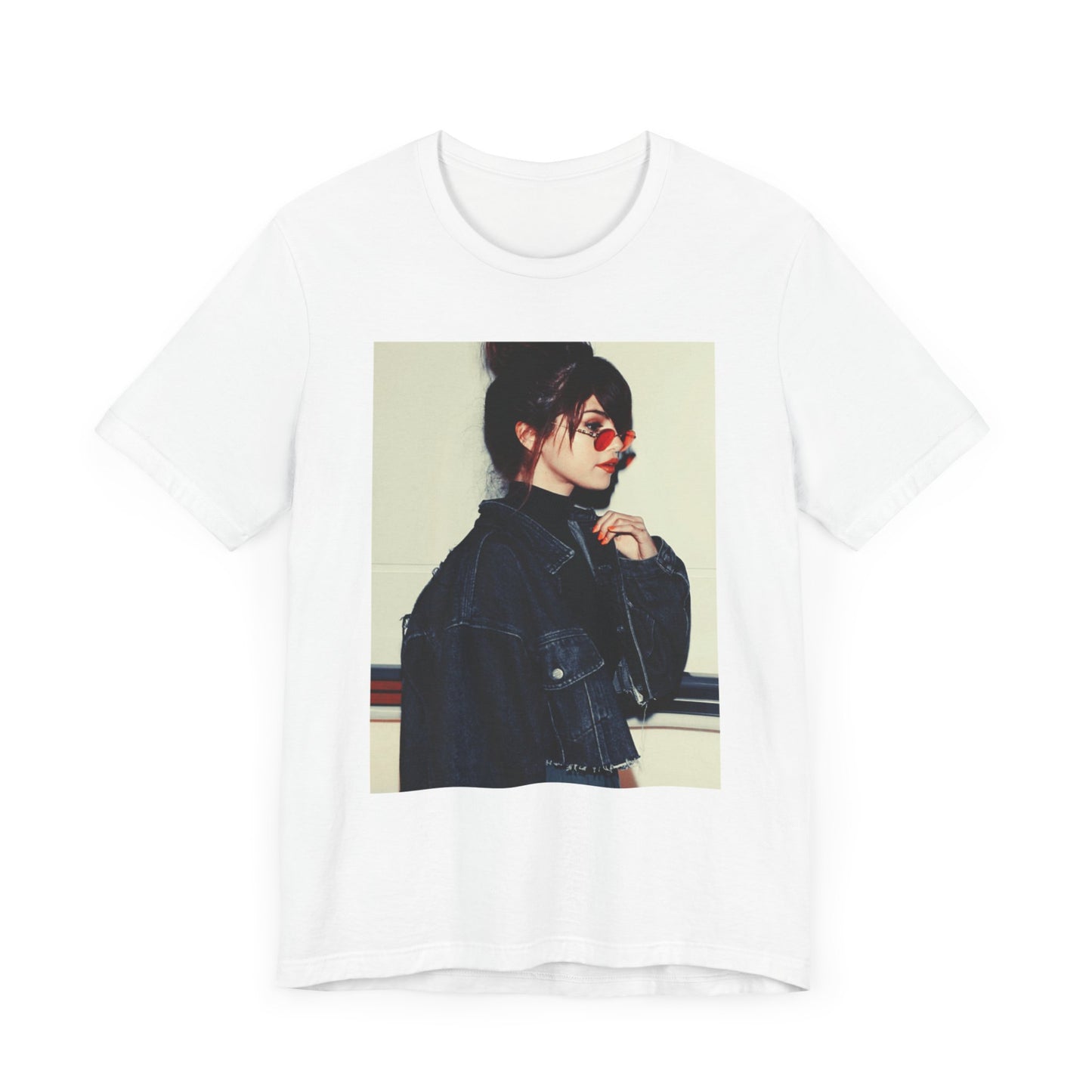 A black graphic t-shirt featuring a bold graphic of Selena Gomez as a pop superstar.