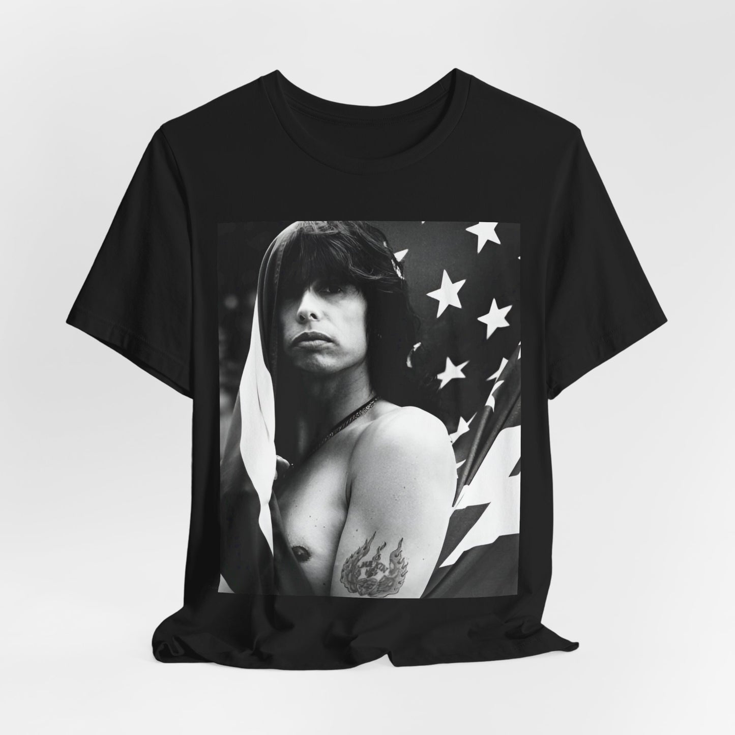 A black graphic t-shirt featuring a retro 70s-style illustration or photo of Aerosmith, integrated with elements of the American flag.