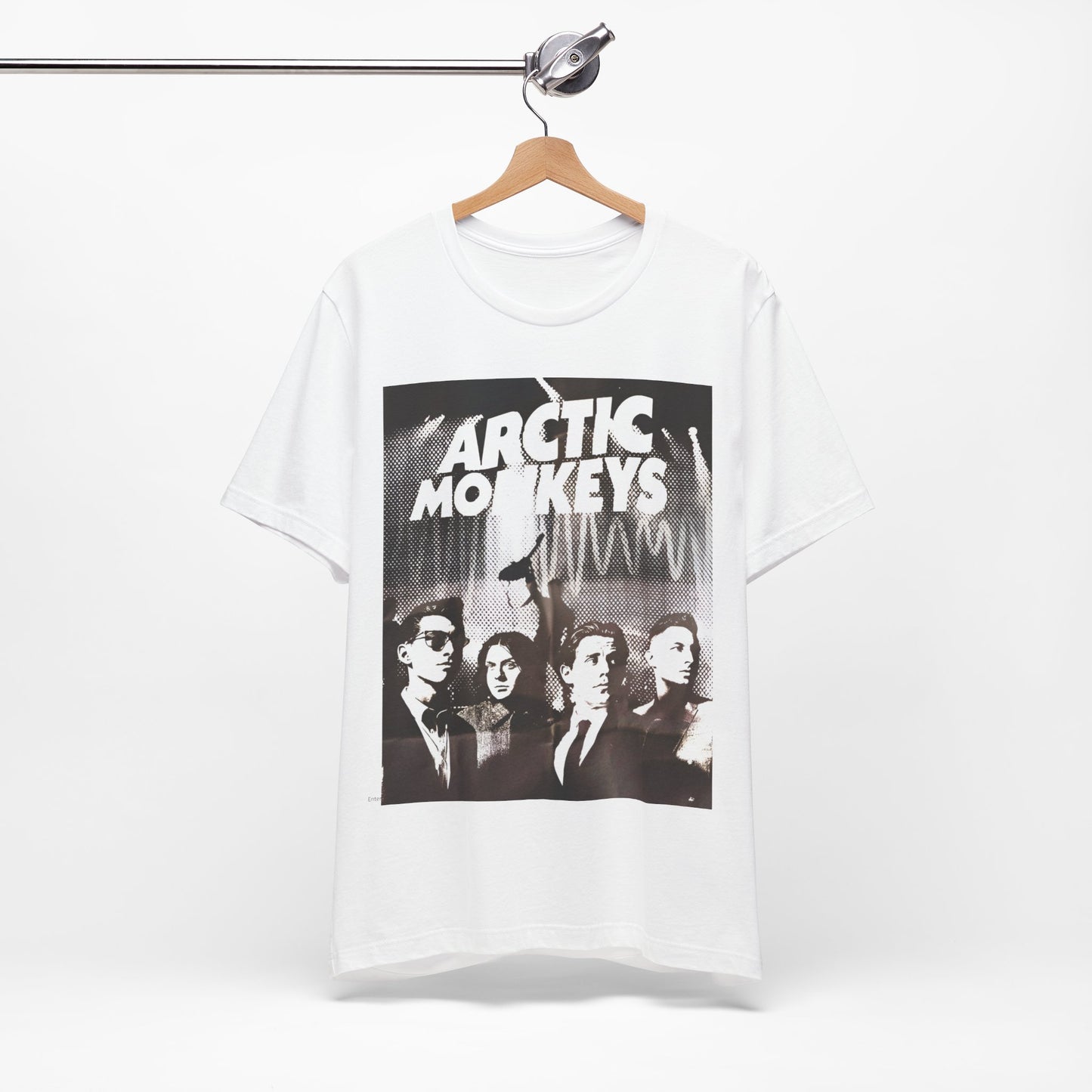 A black graphic t-shirt featuring a retro-style logo for the band Arctic Monkeys.