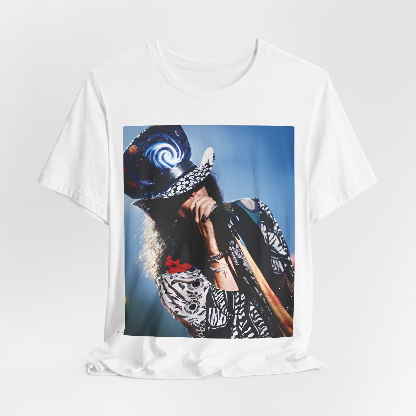 A black graphic t-shirt featuring a vintage 90s photo or illustration of Aerosmith performing live on stage, with band members in dynamic poses.