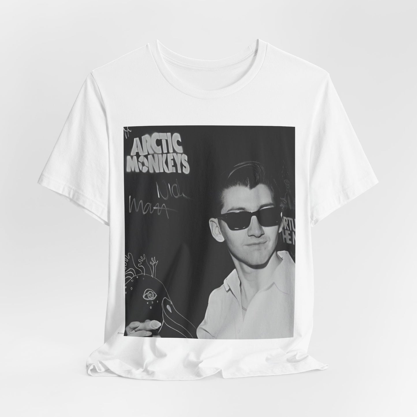 A black graphic t-shirt featuring a black and white portrait photo of Alex Turner from Arctic Monkeys, showing his signature look.