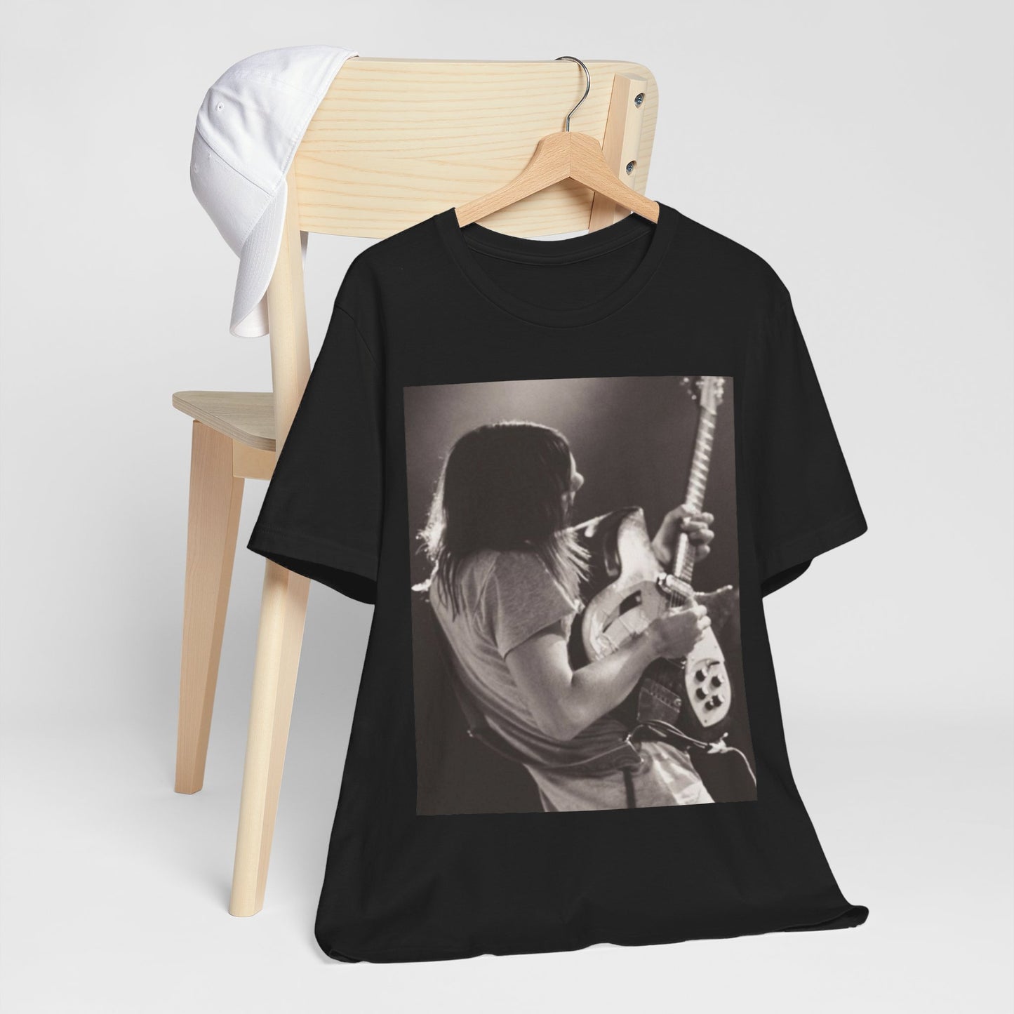 A black graphic t-shirt featuring a black and white graphic or photo of Tame Impala performing live on stage.