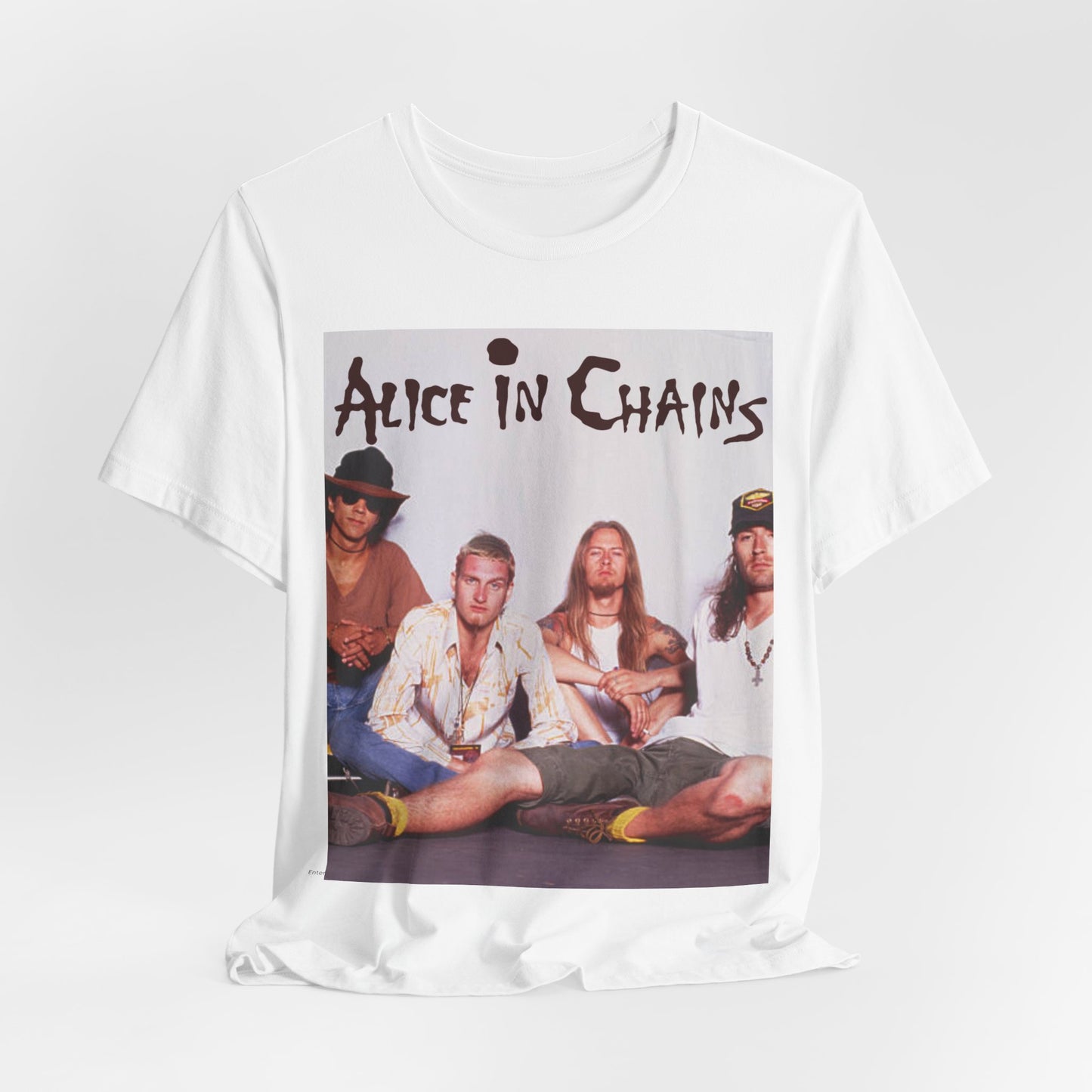 A black graphic t-shirt featuring a classic rock graphic of Alice In Chains from the 1990s, possibly with band members or stylized logo.