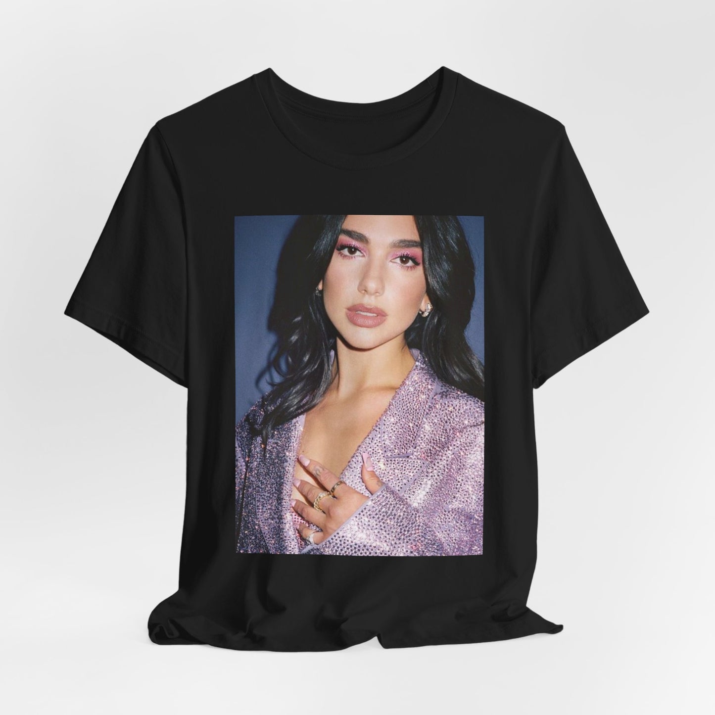 A black graphic t-shirt featuring a retro photo of Dua Lipa as a dance floor queen.
