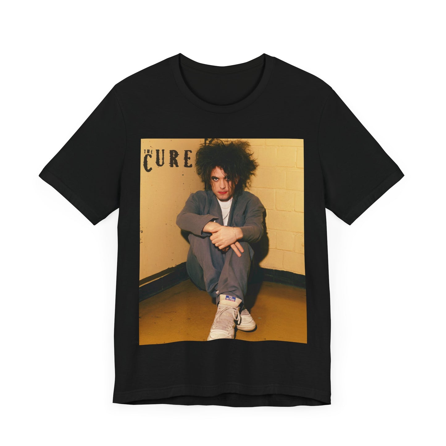 A black graphic t-shirt featuring a bold goth rock superstar graphic of The Cure.