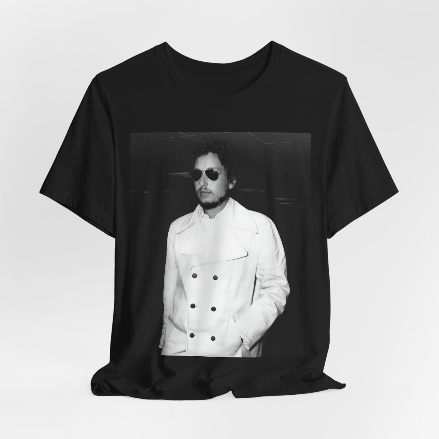 A black graphic t-shirt featuring a vintage black and white photo of Bob Dylan in a contemplative or iconic pose.