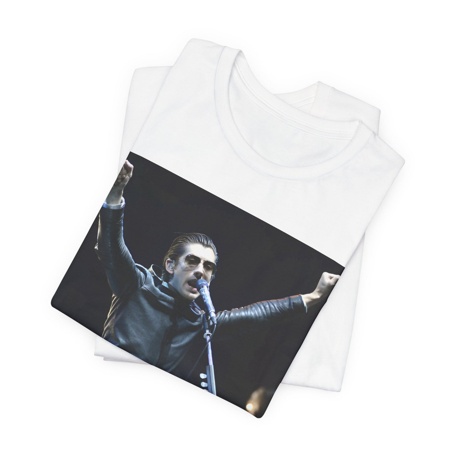 A black graphic t-shirt featuring a graphic or photo of Arctic Monkeys performing live on stage, with a Britpop aesthetic.