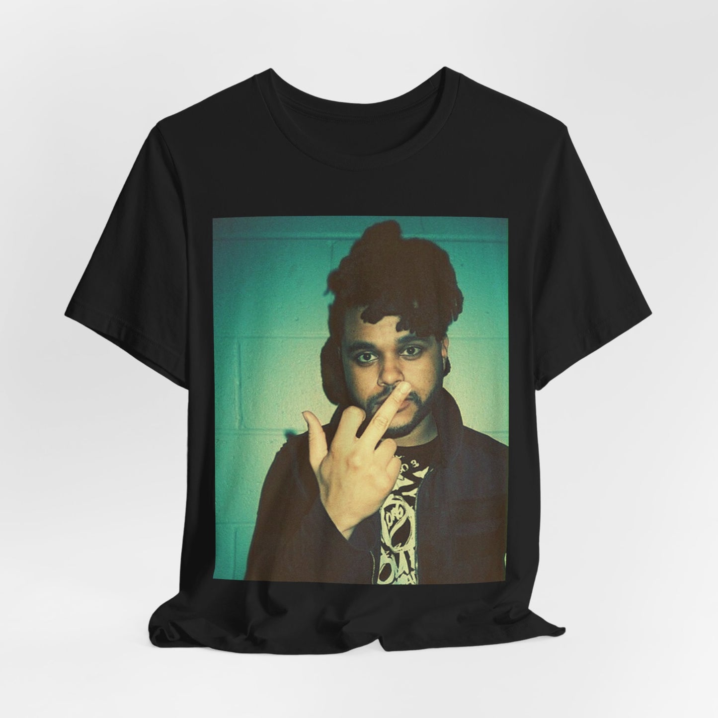 A black graphic t-shirt featuring a graphic of The Weeknd making the middle finger gesture.