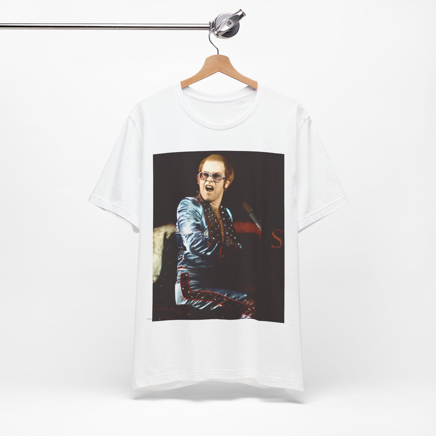 A black graphic t-shirt featuring a retro graphic related to Elton John's 'Rocket Man' song or era.
