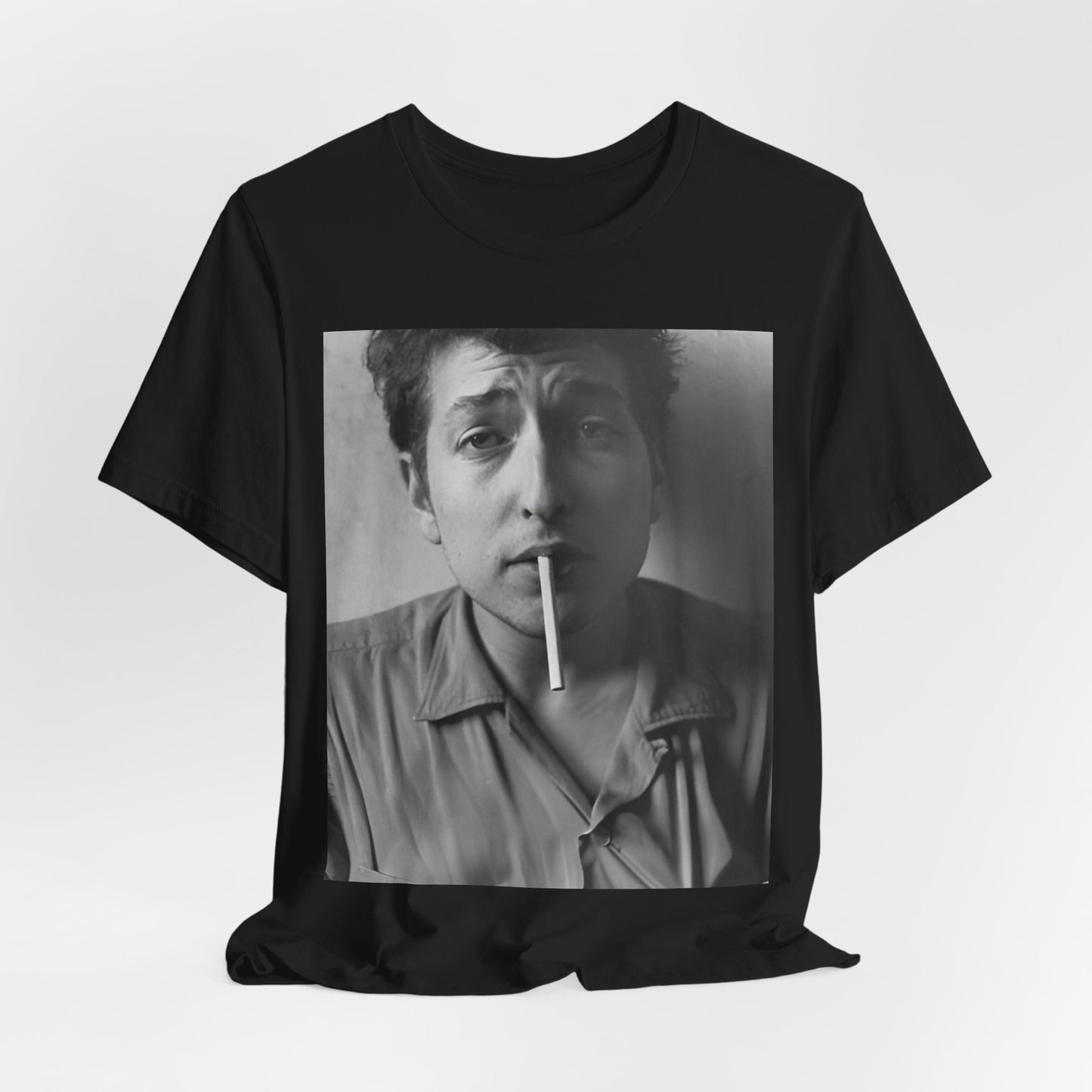 A black graphic t-shirt featuring a graphic of Bob Dylan from the 60s, depicted as a renegade folk icon.