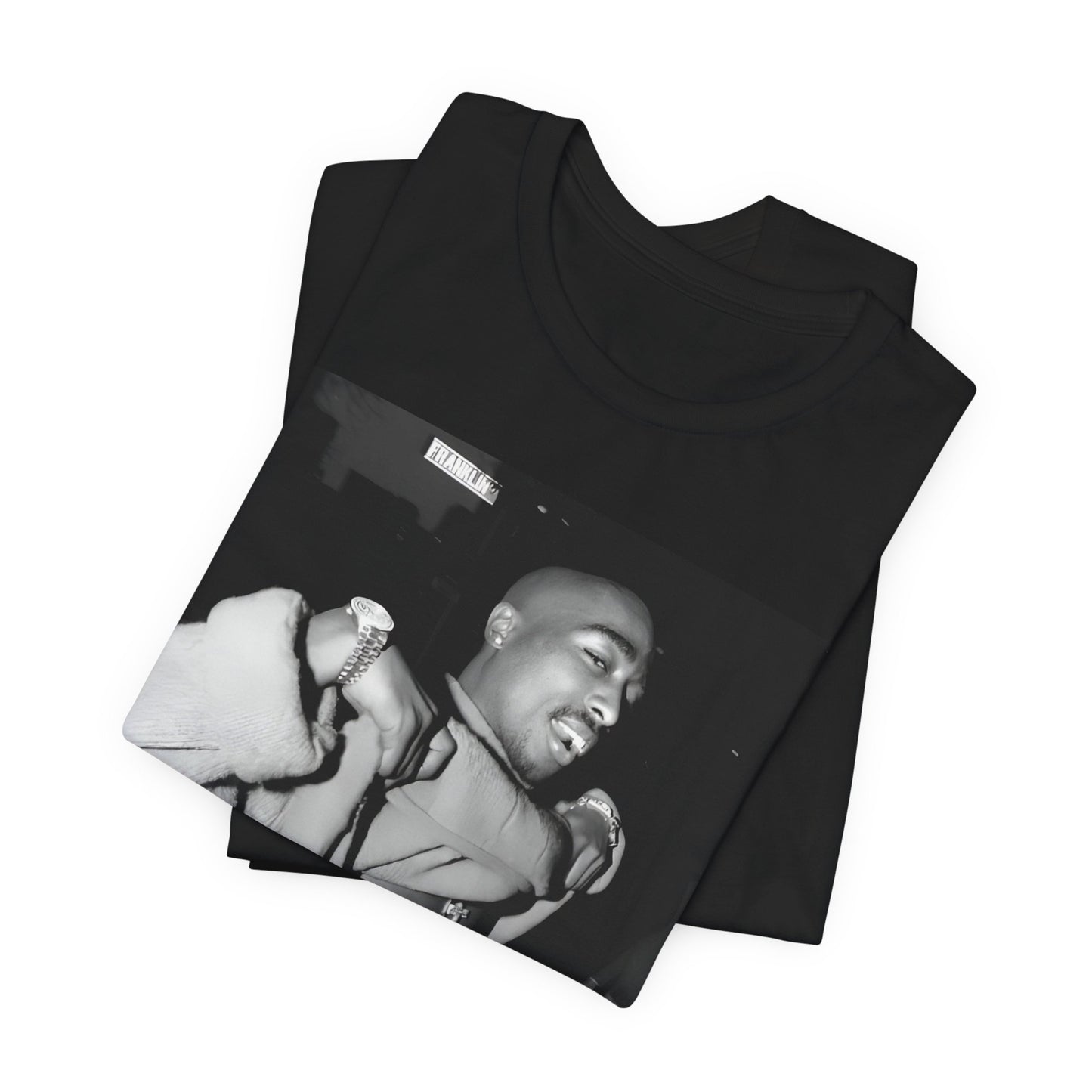 A black graphic t-shirt featuring a vintage hip hop icon graphic of Tupac.