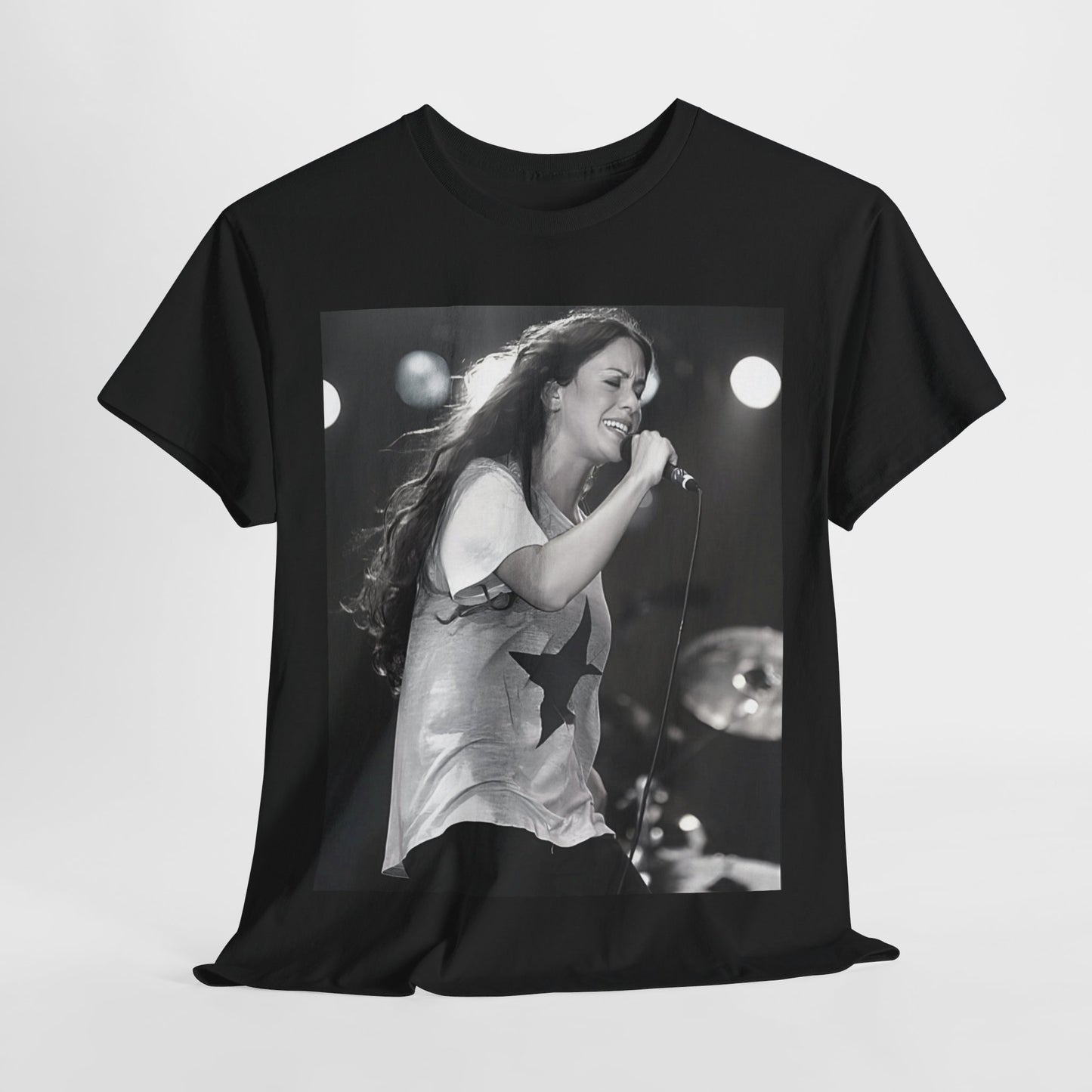 A black graphic t-shirt featuring a photo of Alanis Morissette performing live on stage in the 1990s, with a dynamic expression.