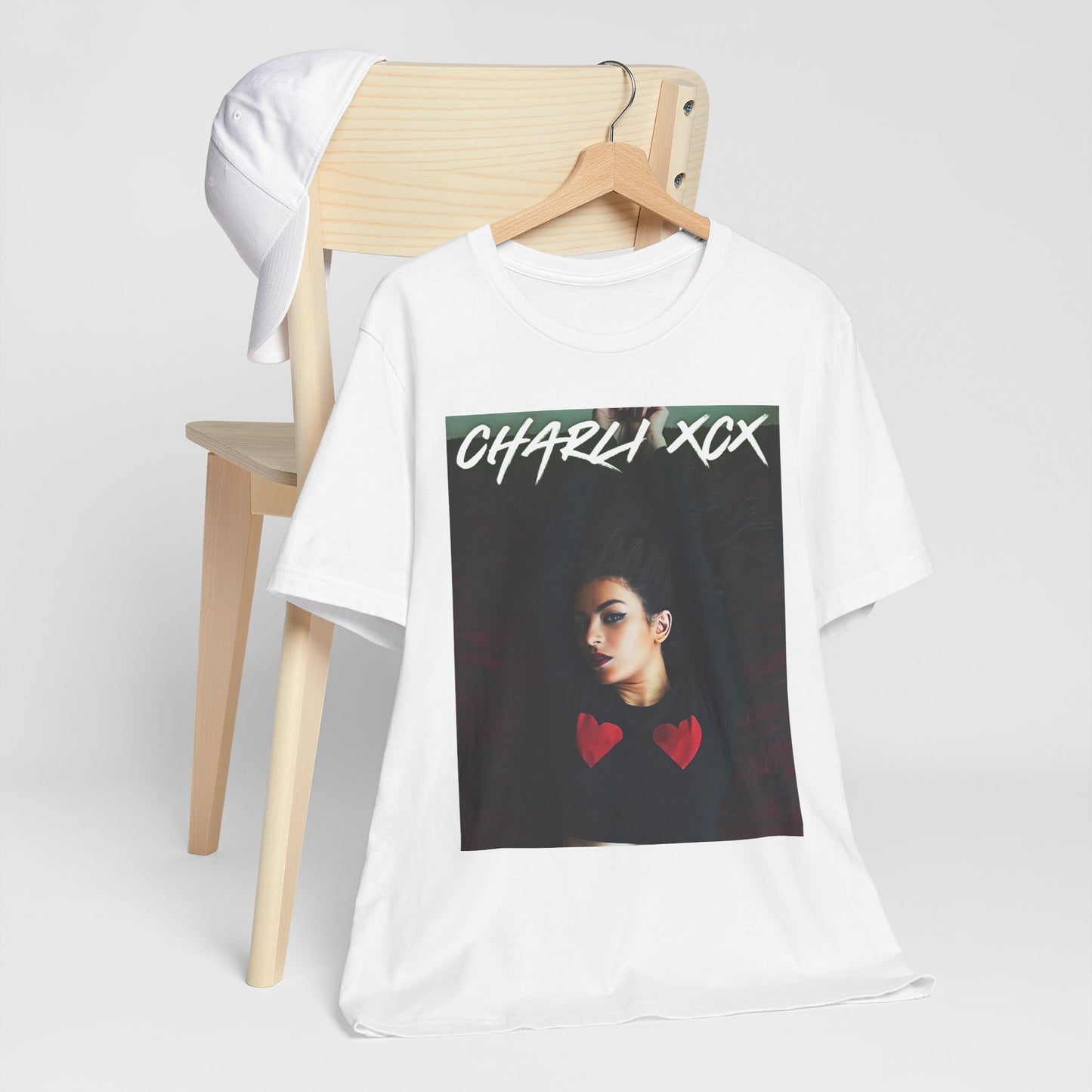 A black graphic t-shirt featuring a graphic of Charli XCX, designed with a future pop diva aesthetic.