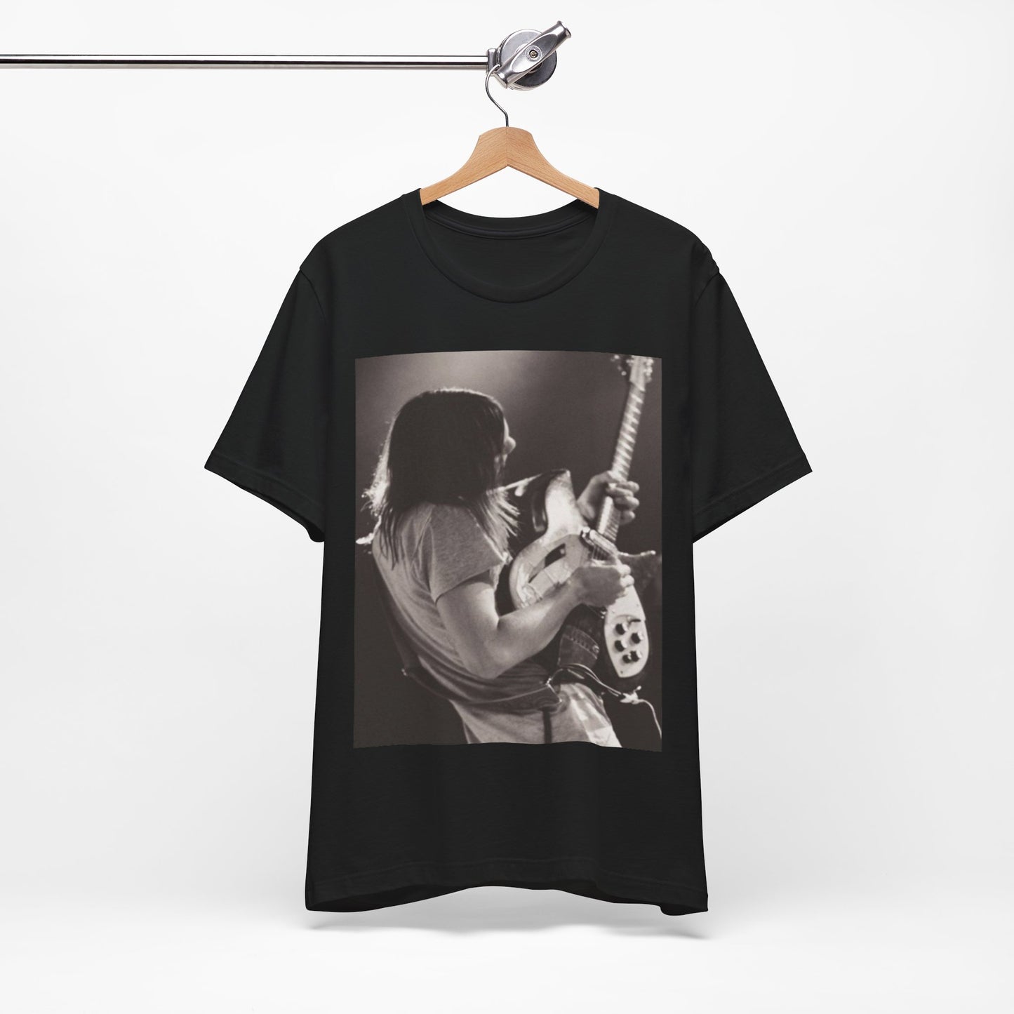 A black graphic t-shirt featuring a black and white graphic or photo of Tame Impala performing live on stage.