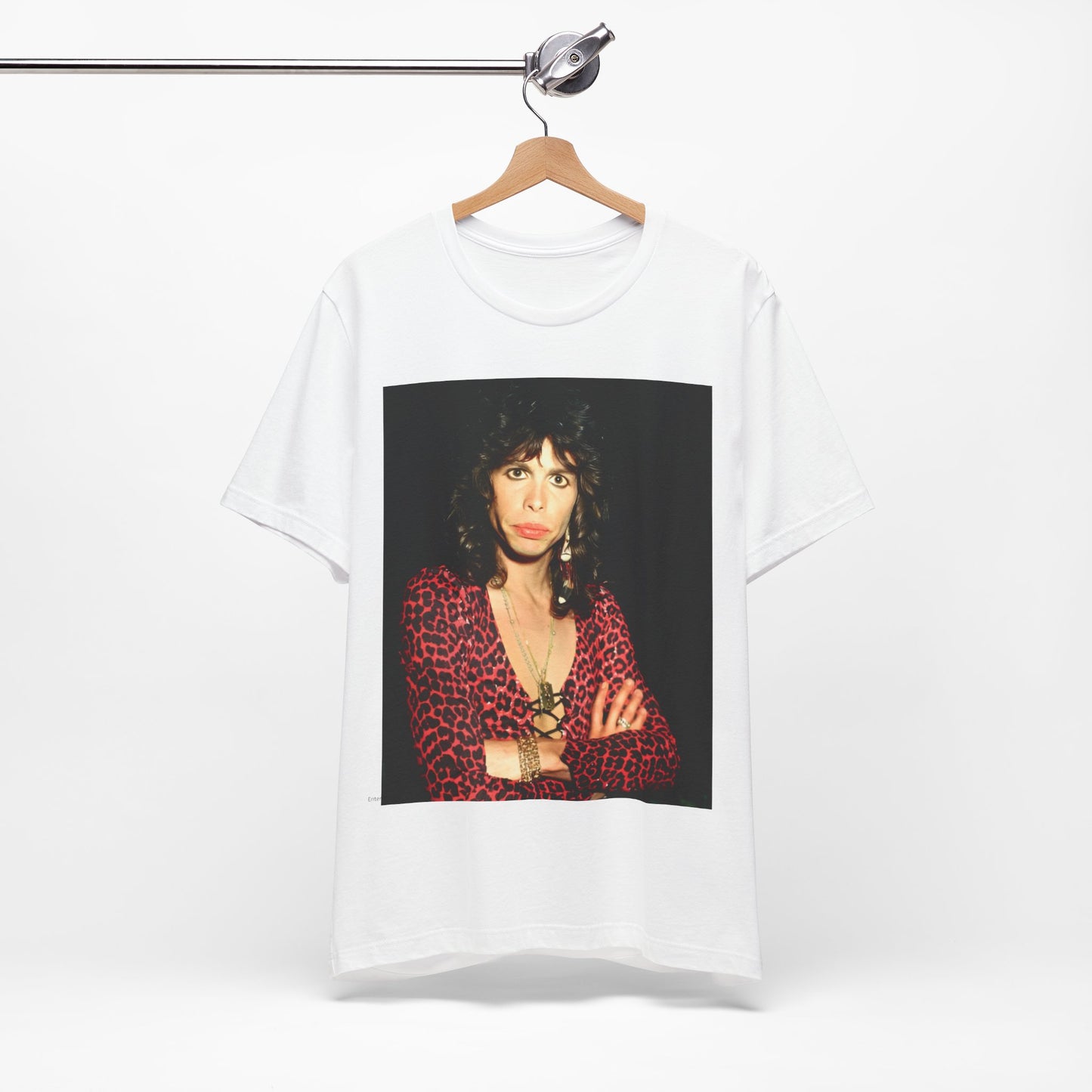A black graphic t-shirt featuring a vintage 70s-inspired design with Aerosmith branding, incorporating a prominent leopard print pattern.