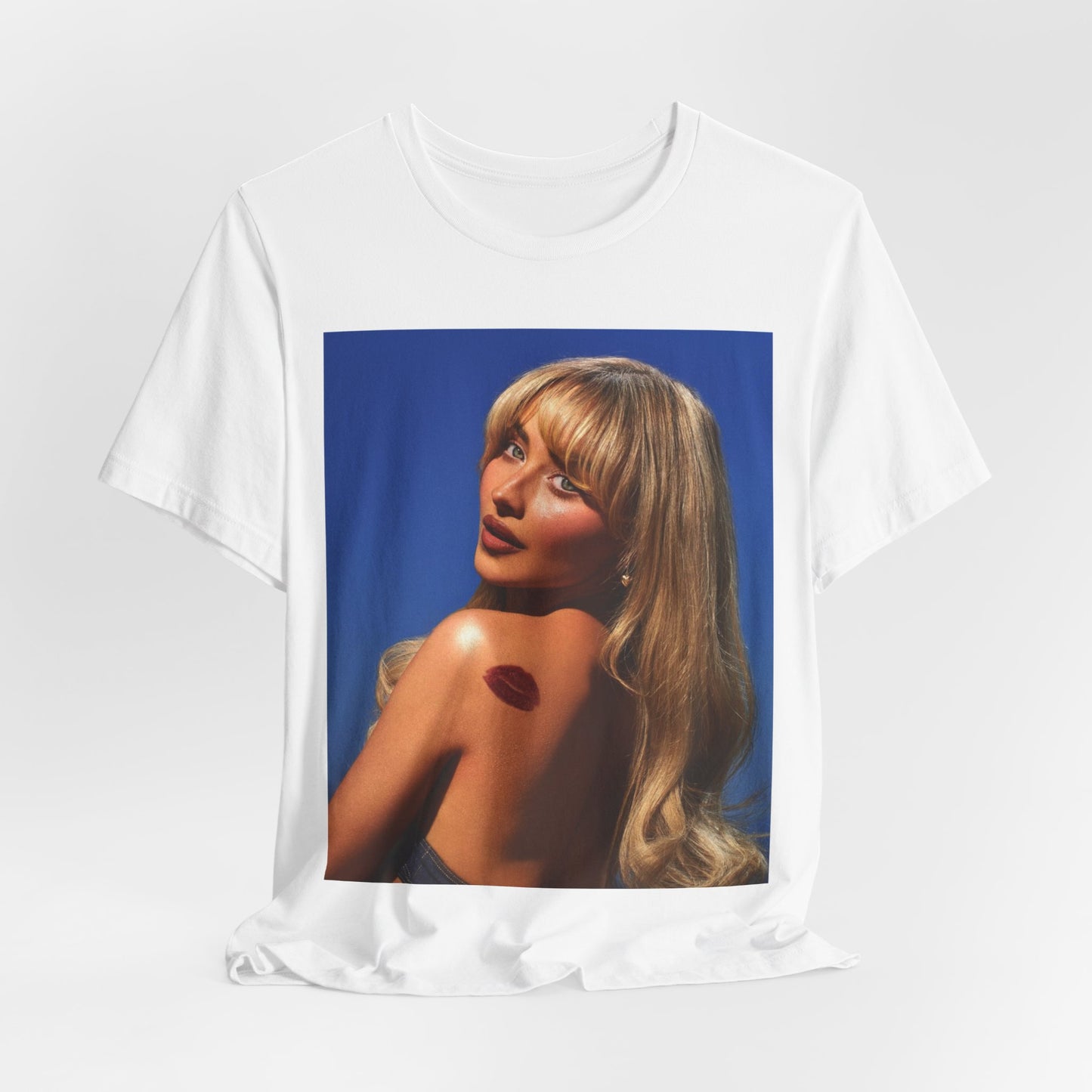 A black graphic t-shirt featuring a stylized graphic of Sabrina Carpenter, designed with a modern pop aesthetic.