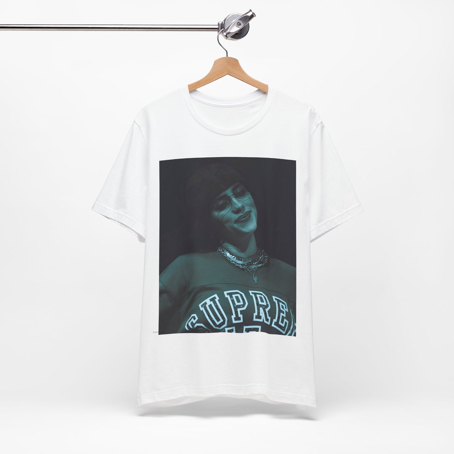 A powerful, close-up portrait of Billie Eilish with a direct and intense stare, printed on a graphic t-shirt.