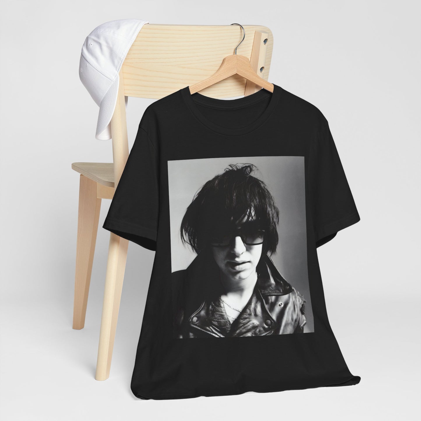 A black graphic t-shirt featuring a graphic related to The Strokes' 'Reptilia' song or era.