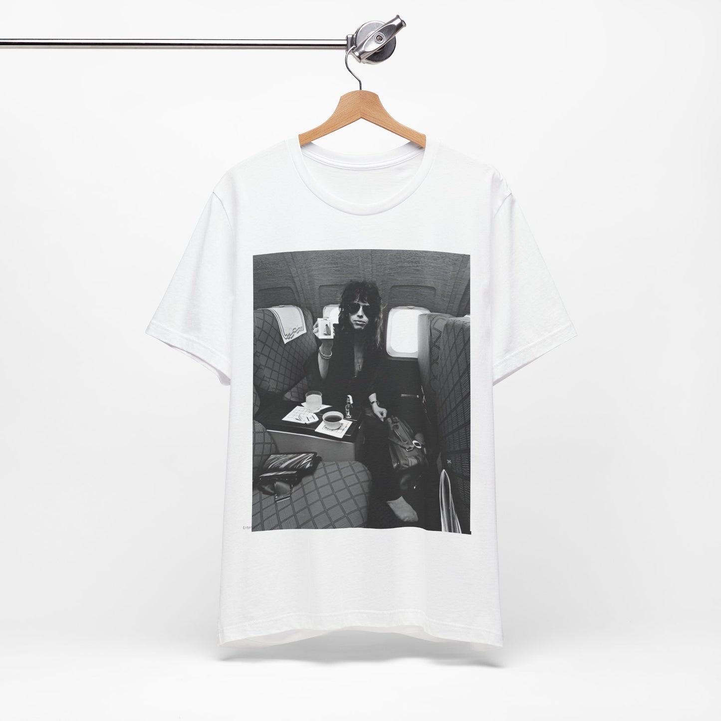 A black graphic t-shirt featuring a vintage 70s-style illustration of an airplane with Aerosmith branding, representing their tour plane from that era.