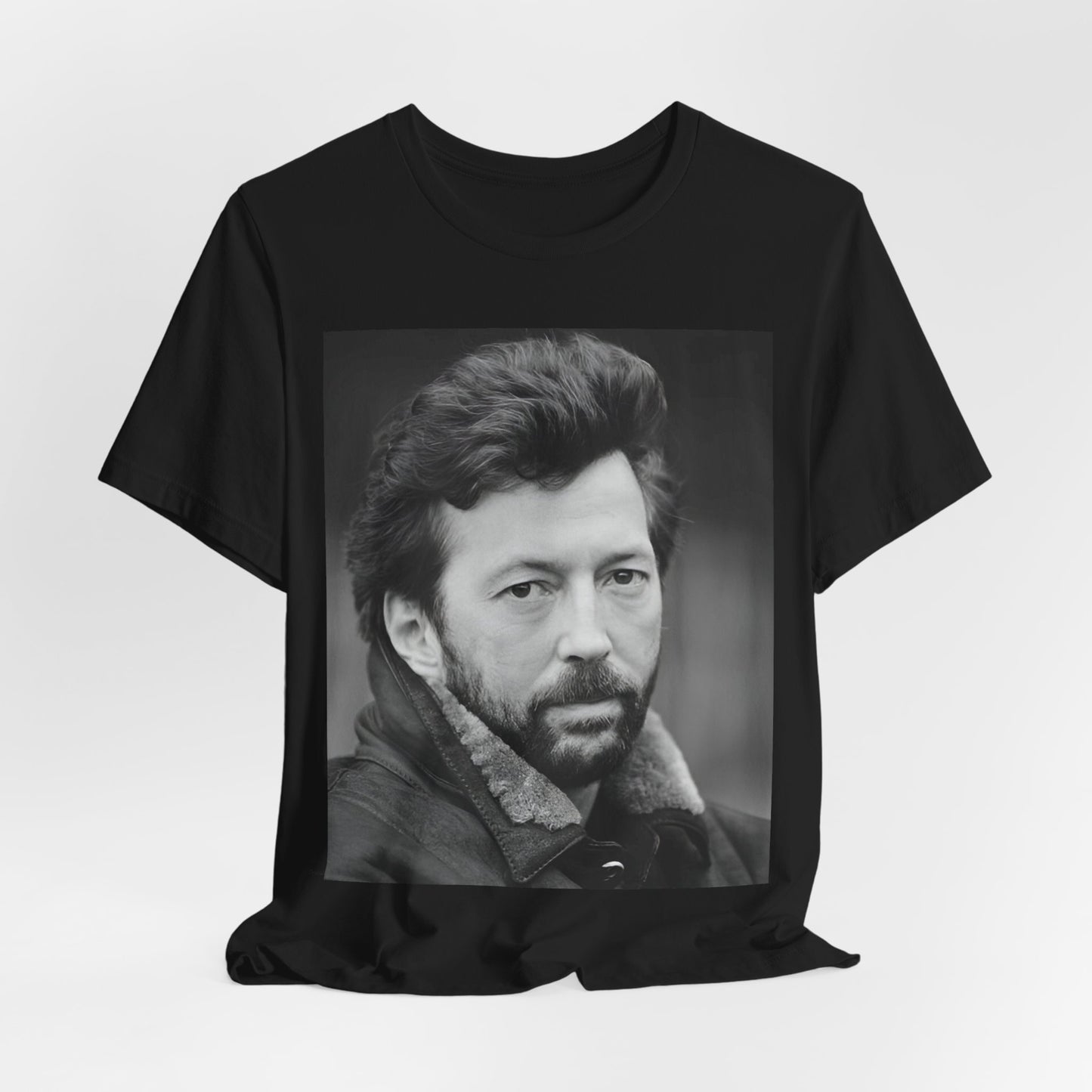 A black graphic t-shirt featuring a 70s rock aesthetic graphic of Eric Clapton.