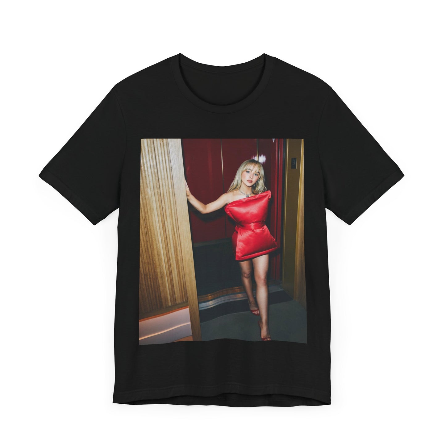 A black graphic t-shirt featuring a graphic of Sabrina Carpenter with 'hot pop vibes'.