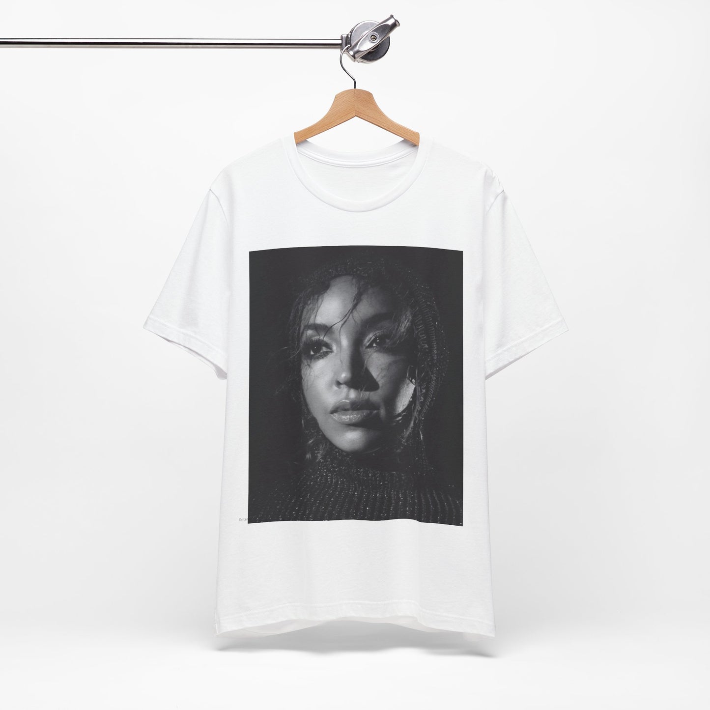 A black graphic t-shirt featuring a black and white portrait photo of Tinashe.
