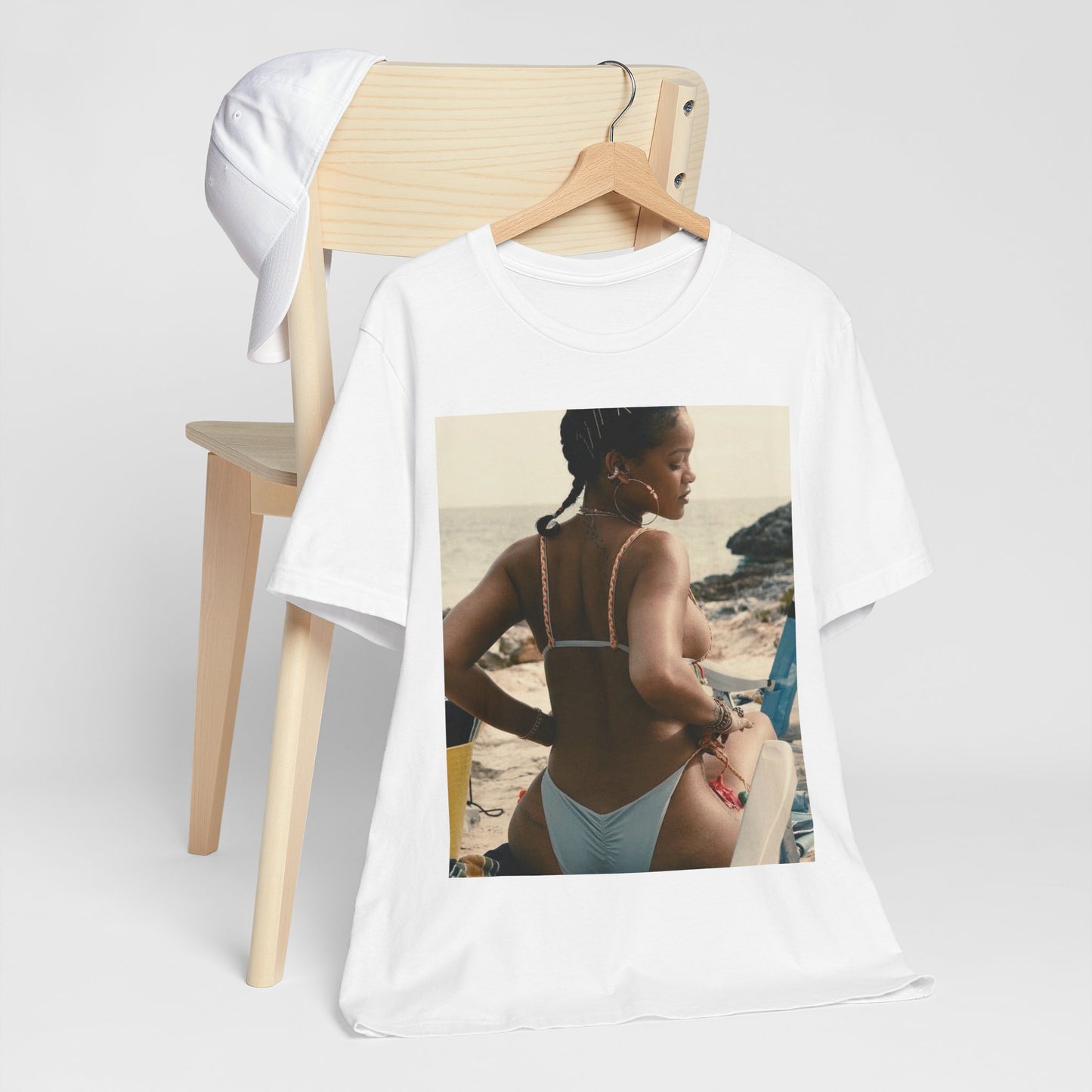 A black graphic t-shirt featuring a graphic of Rihanna as a bikini babe in paradise.