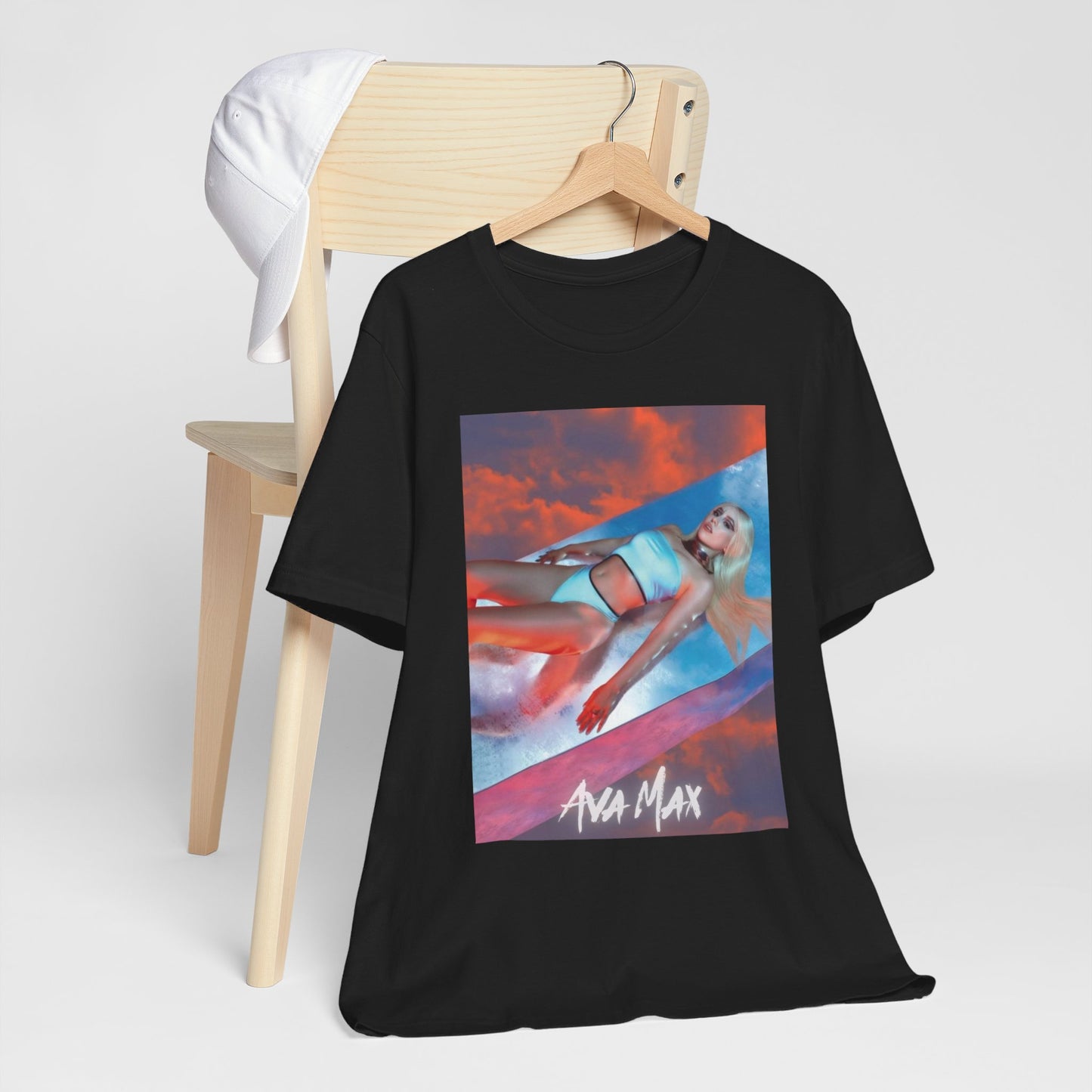 A black graphic t-shirt featuring a neon pop art style graphic of Ava Max, with bright, glowing colors.