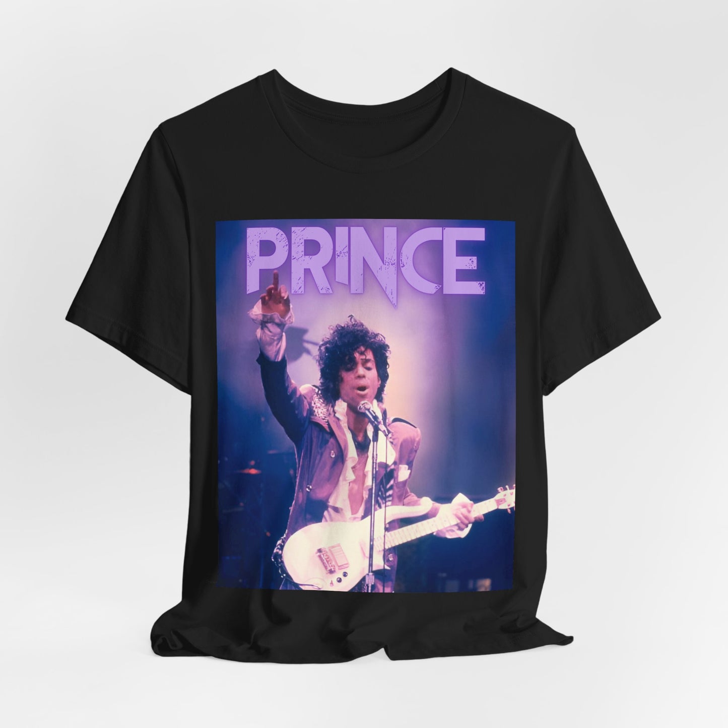 A black graphic t-shirt featuring a retro graphic related to Prince's 'Purple Rain' album era.