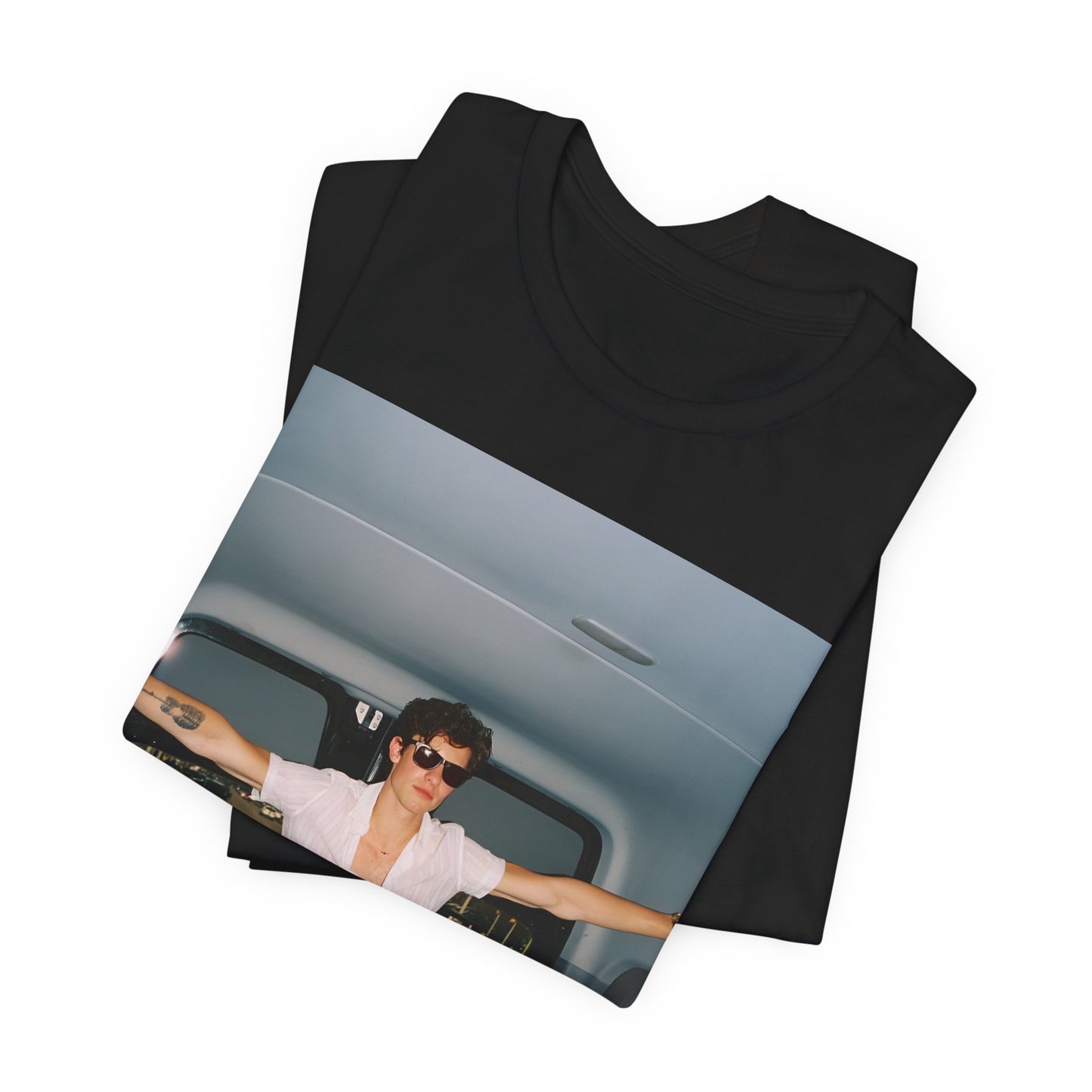 A black graphic t-shirt featuring a graphic of Shawn Mendes with a classic confident look.