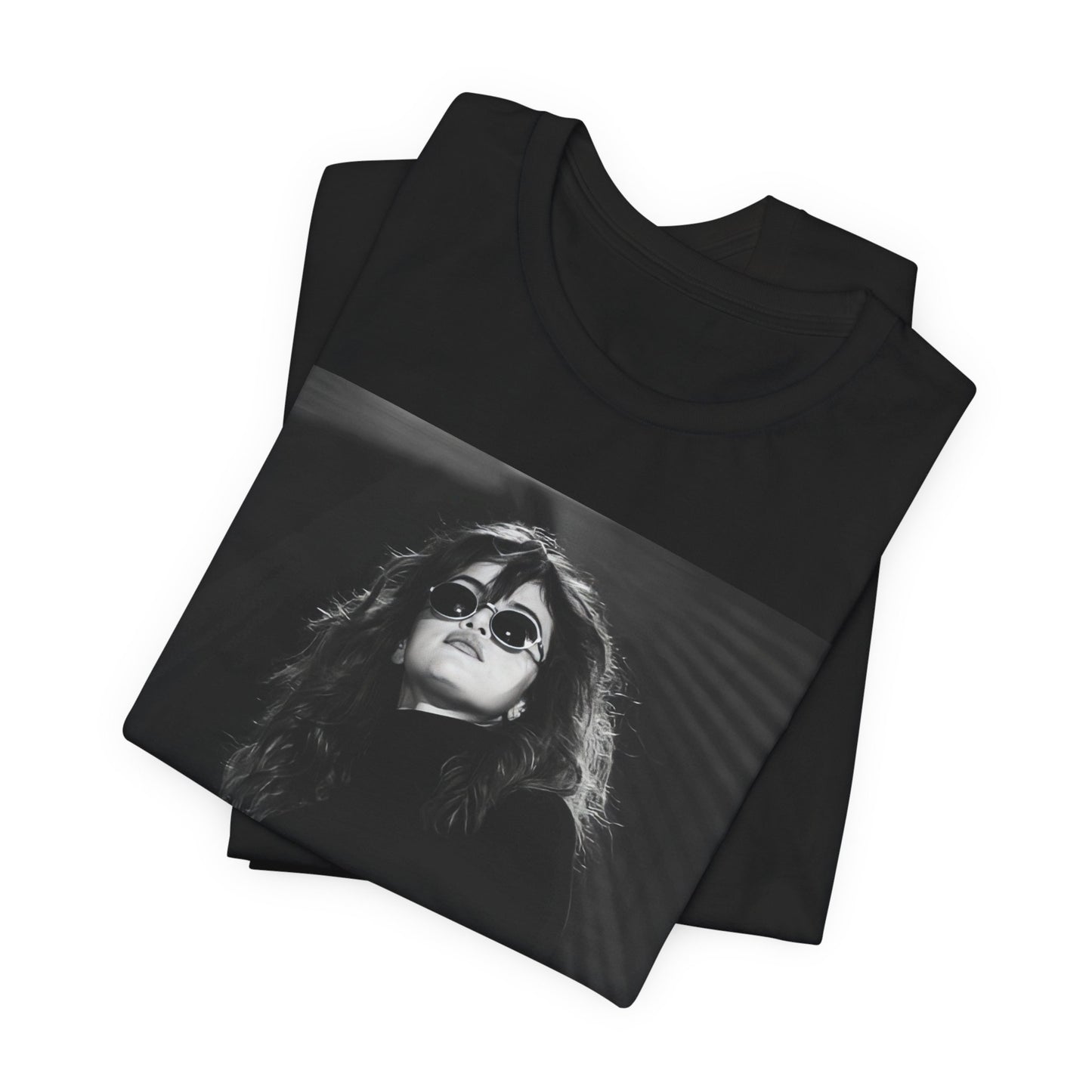 A black graphic t-shirt featuring a black and white, monochrome graphic or photo of Selena Gomez.