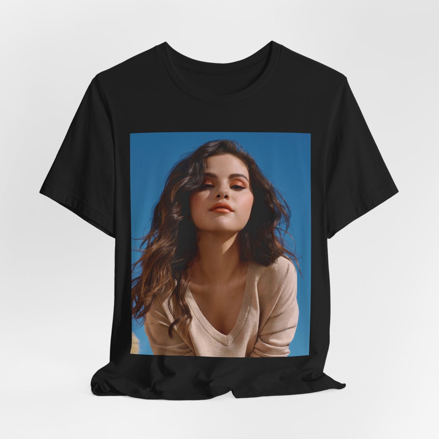 A black graphic t-shirt featuring a vintage pop icon graphic of Selena Gomez.