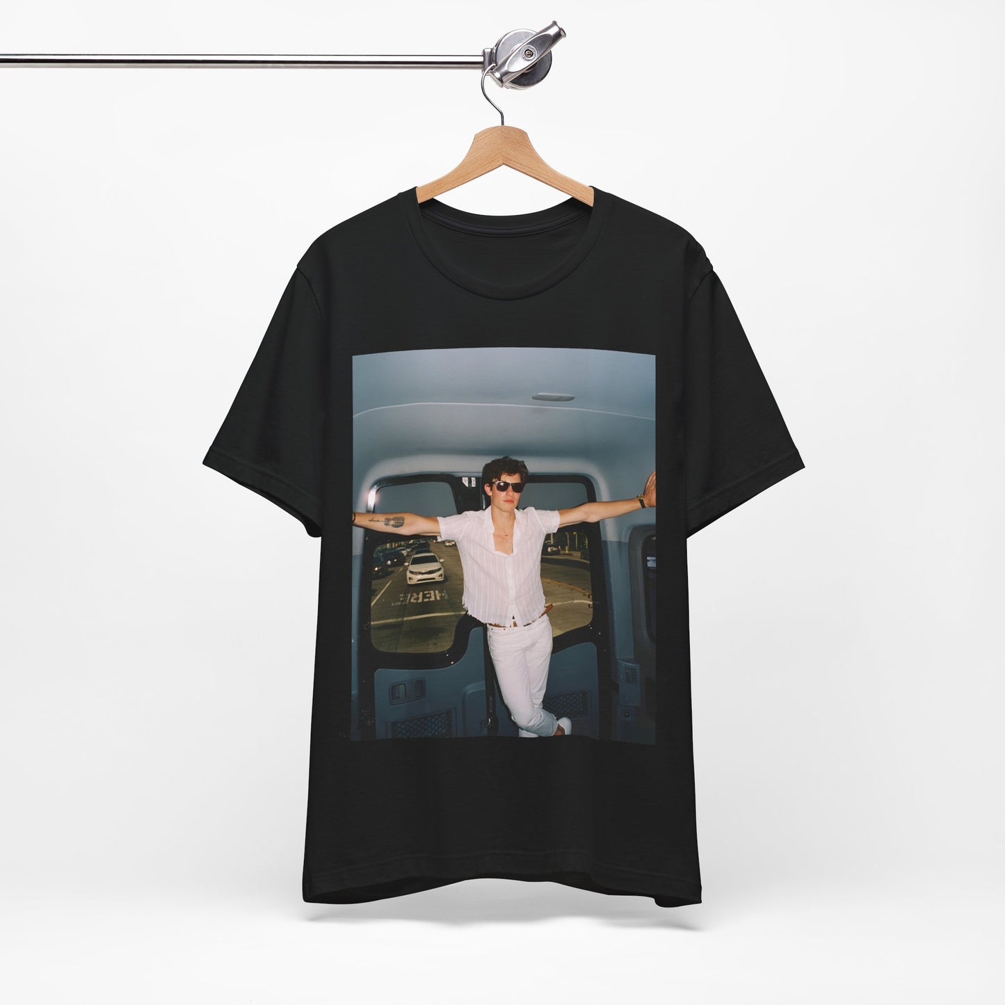 A black graphic t-shirt featuring a graphic of Shawn Mendes with a classic confident look.