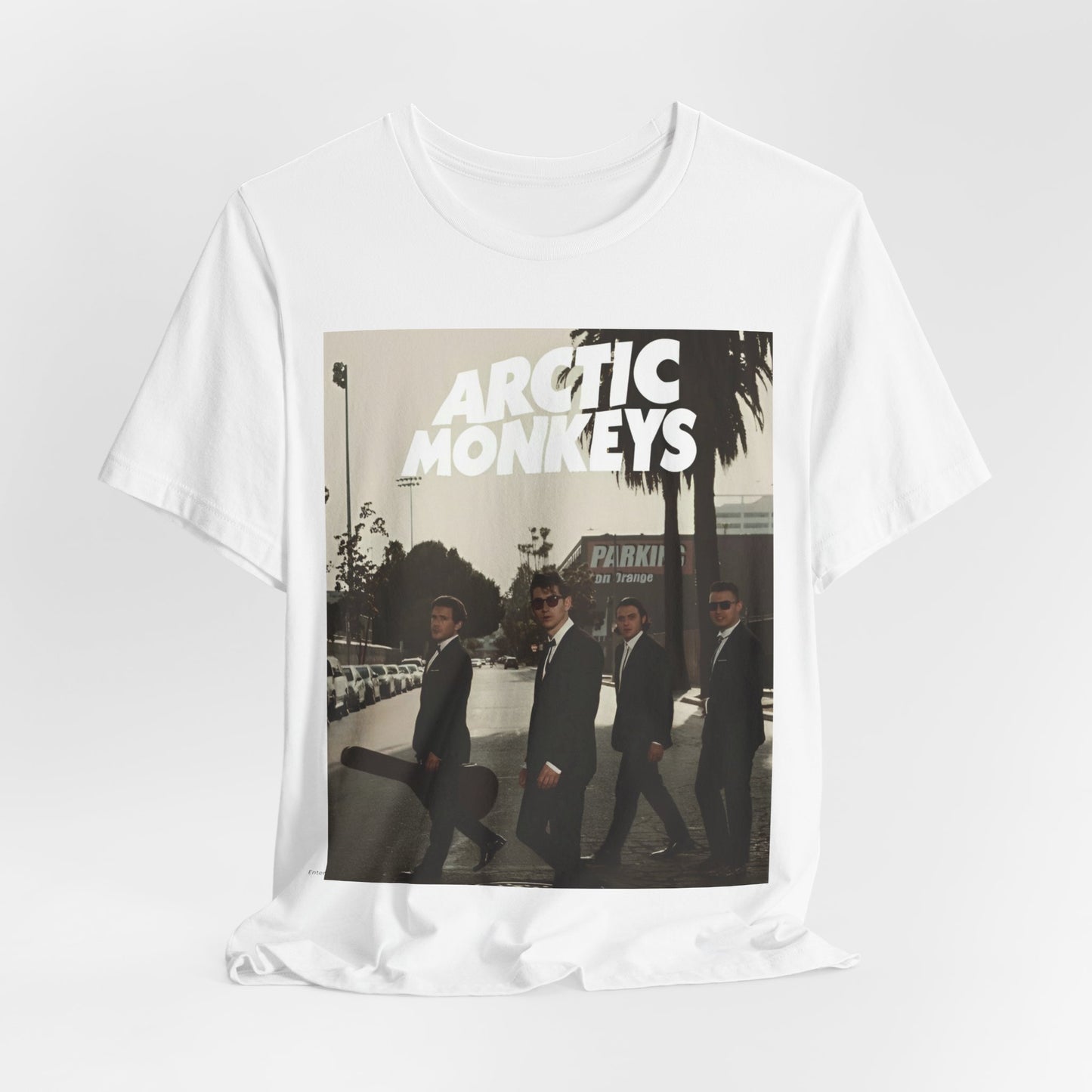 A black graphic t-shirt featuring Arctic Monkeys in a pose or setting similar to the iconic 'Abbey Road' album cover.