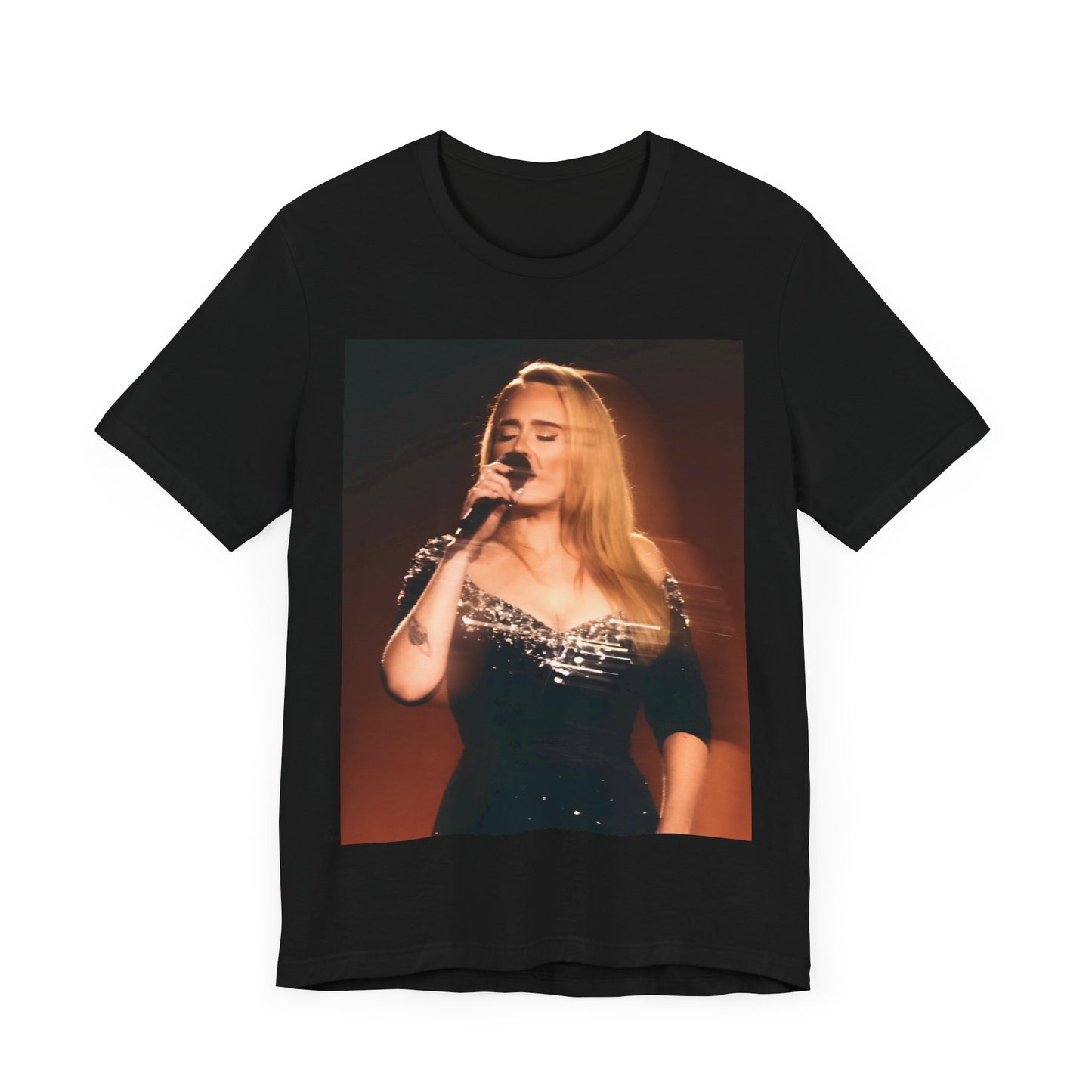 A black graphic t-shirt featuring a stylized image or photo of Adele related to her Las Vegas residency, possibly with elements of stage lighting or show branding.