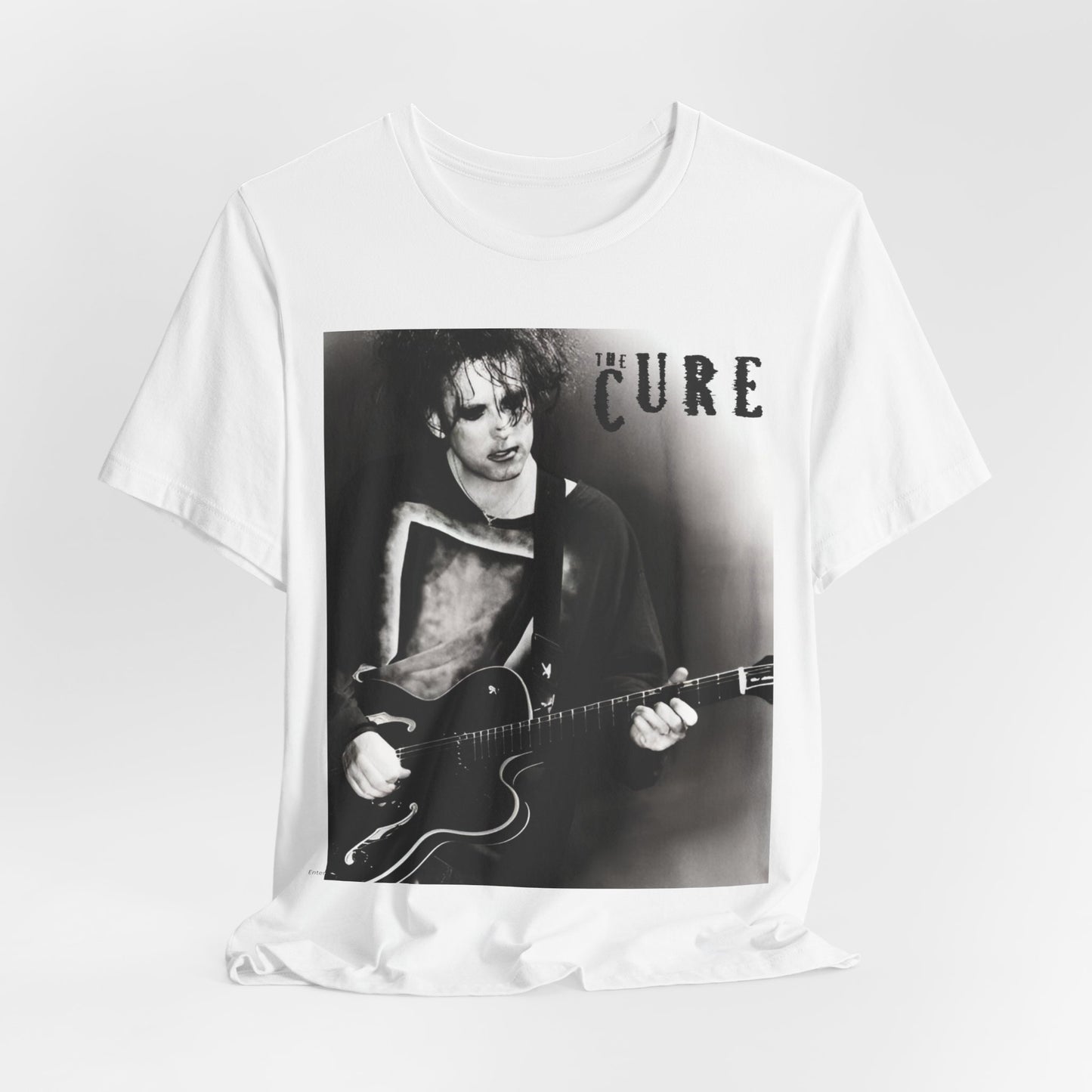 A black graphic t-shirt featuring a vintage goth rock graphic of The Cure.