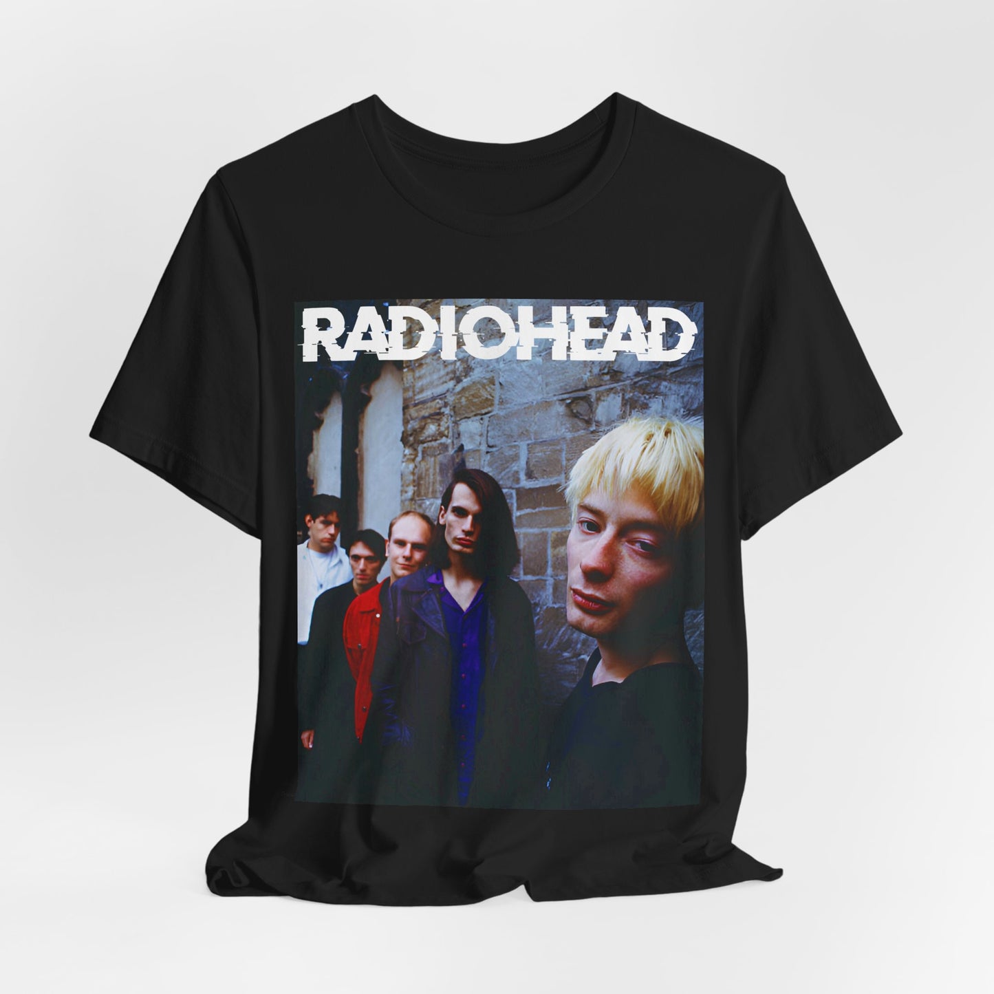 A black graphic t-shirt featuring a 90s graphic related to Radiohead's 'Karma Police' song or era.