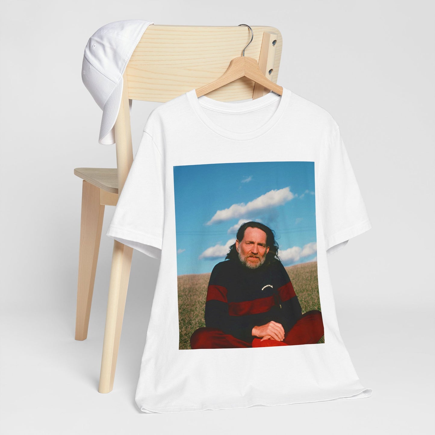 A black graphic t-shirt featuring a classic outlaw country graphic of Willie Nelson.