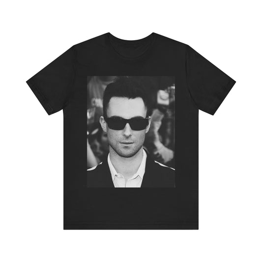 A black and white high-fashion photoshoot photo of Adam Levine, frontman of Maroon 5, looking confidently at the camera.
