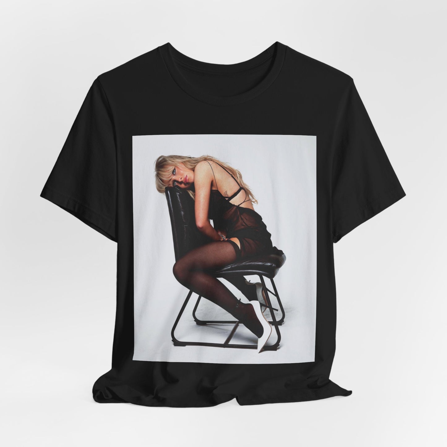 A black graphic t-shirt featuring a playful pop art style graphic of Sabrina Carpenter.