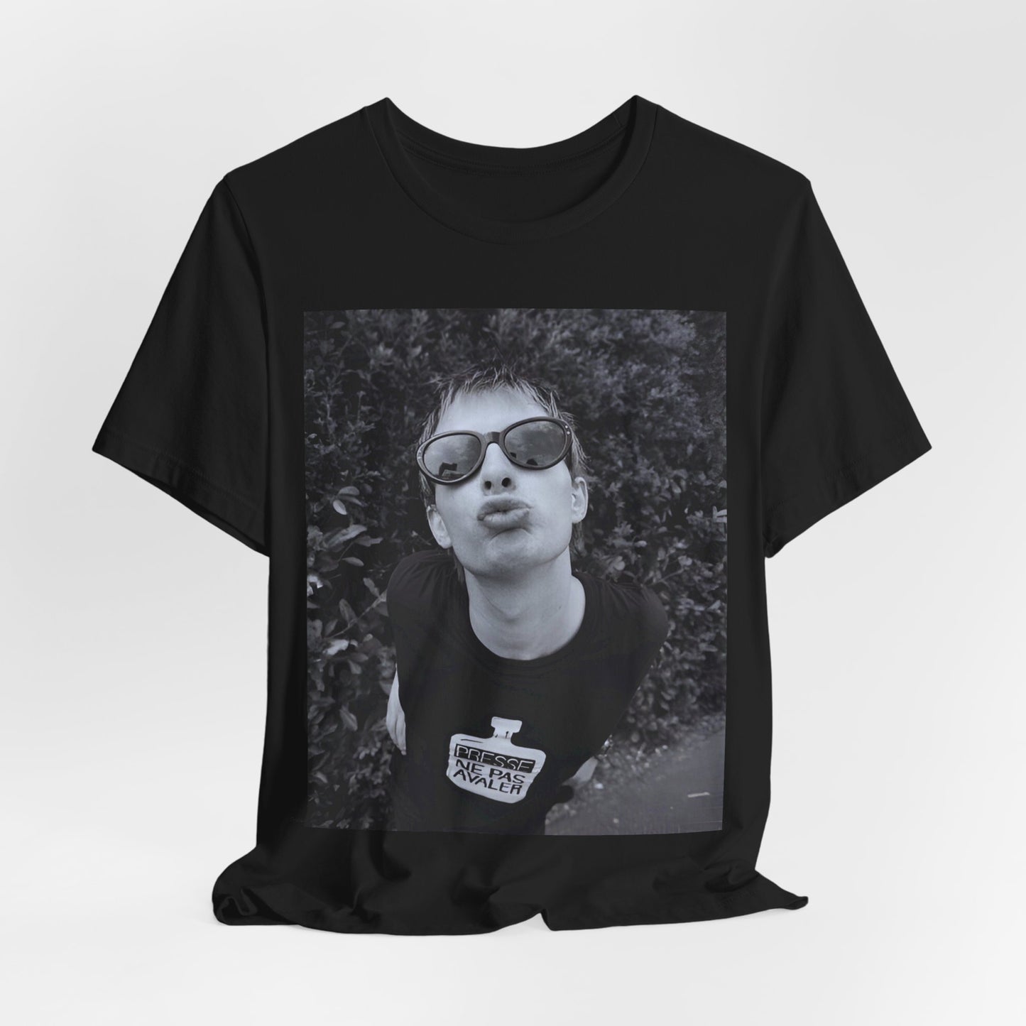 A black graphic t-shirt featuring a retro 90s graphic of Thom Yorke from Radiohead.