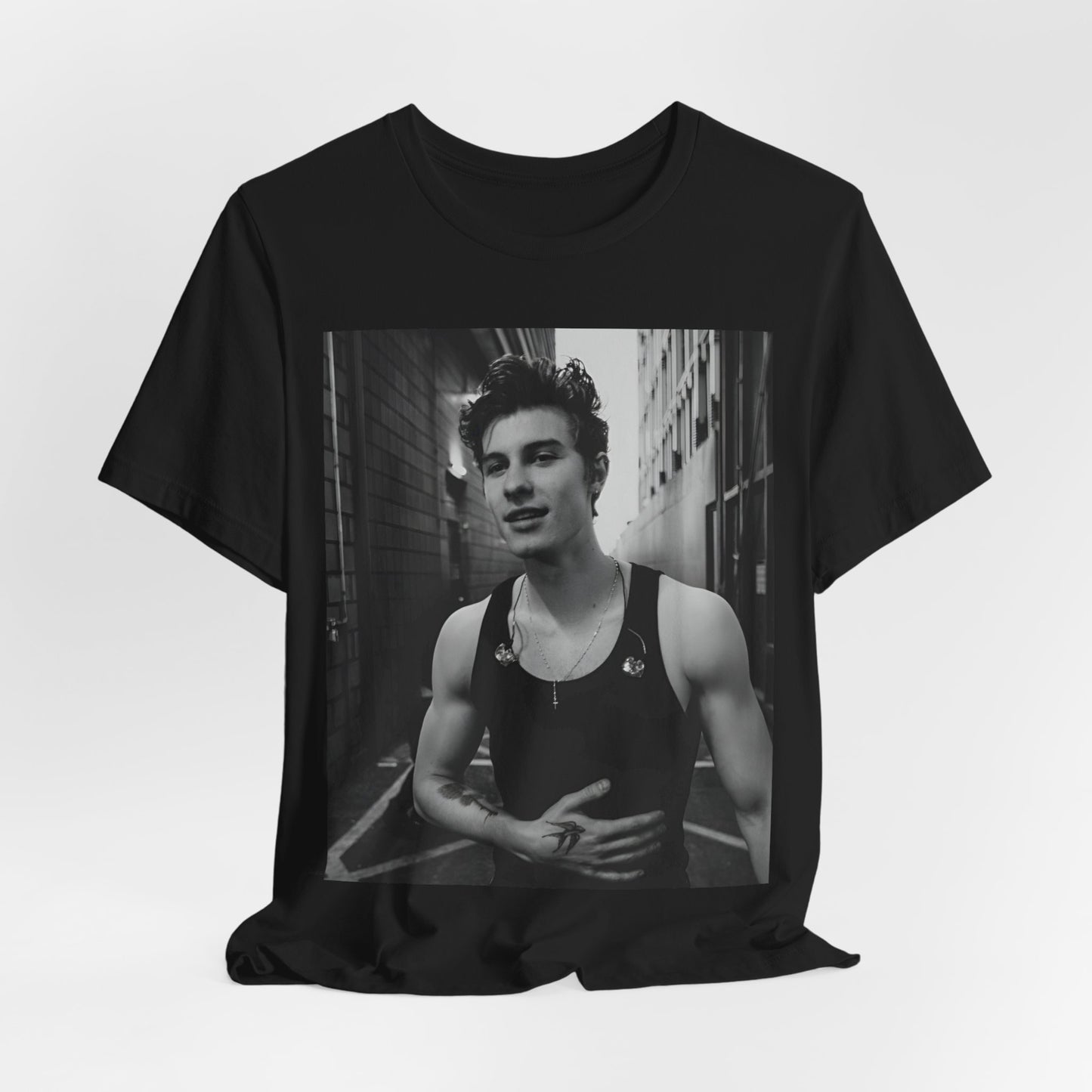A black graphic t-shirt featuring a vintage black and white portrait graphic or photo of Shawn Mendes.