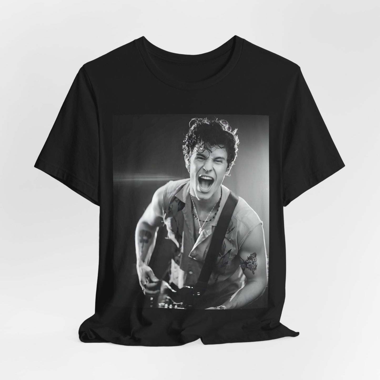 A black graphic t-shirt featuring a black and white photo of Shawn Mendes, emphasizing his charm.
