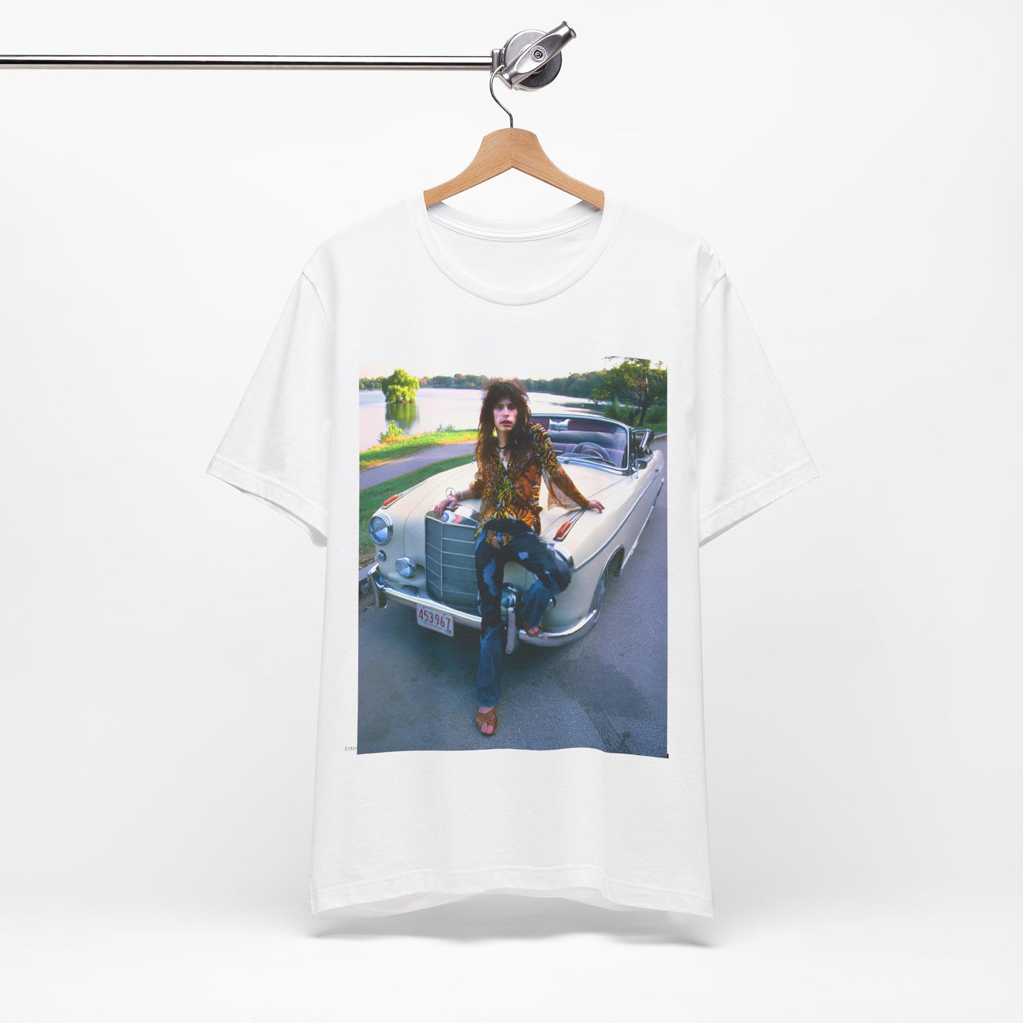 A black graphic t-shirt featuring a retro 70s photo of Aerosmith band members in a bohemian style, posing with a classic Mercedes car.