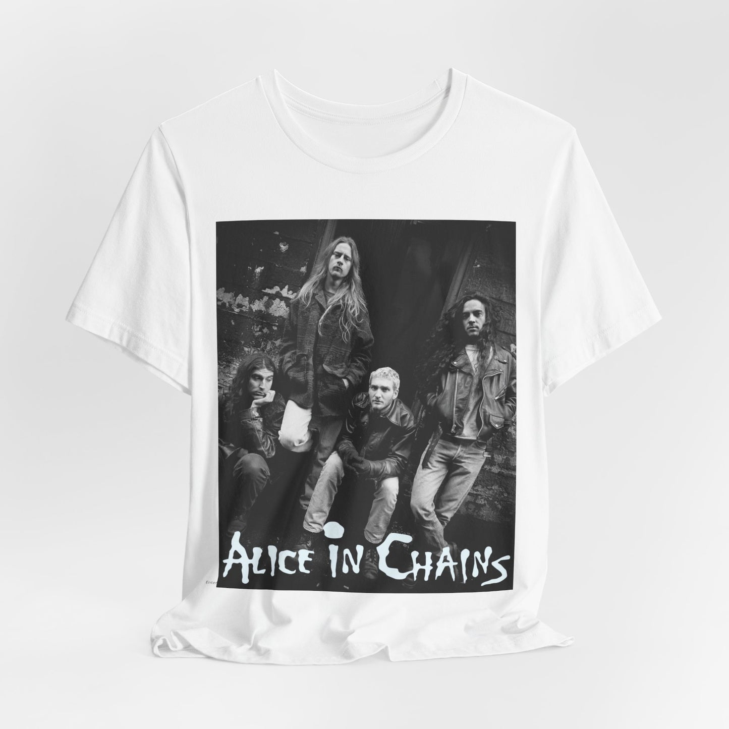 A black graphic t-shirt featuring a 90s black and white photographic portrait of the band Alice In Chains, capturing their iconic grunge look.