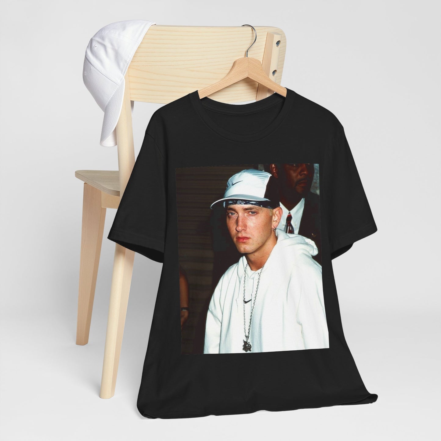 A black graphic t-shirt featuring a retro graphic or photo of Eminem in a backstage setting.