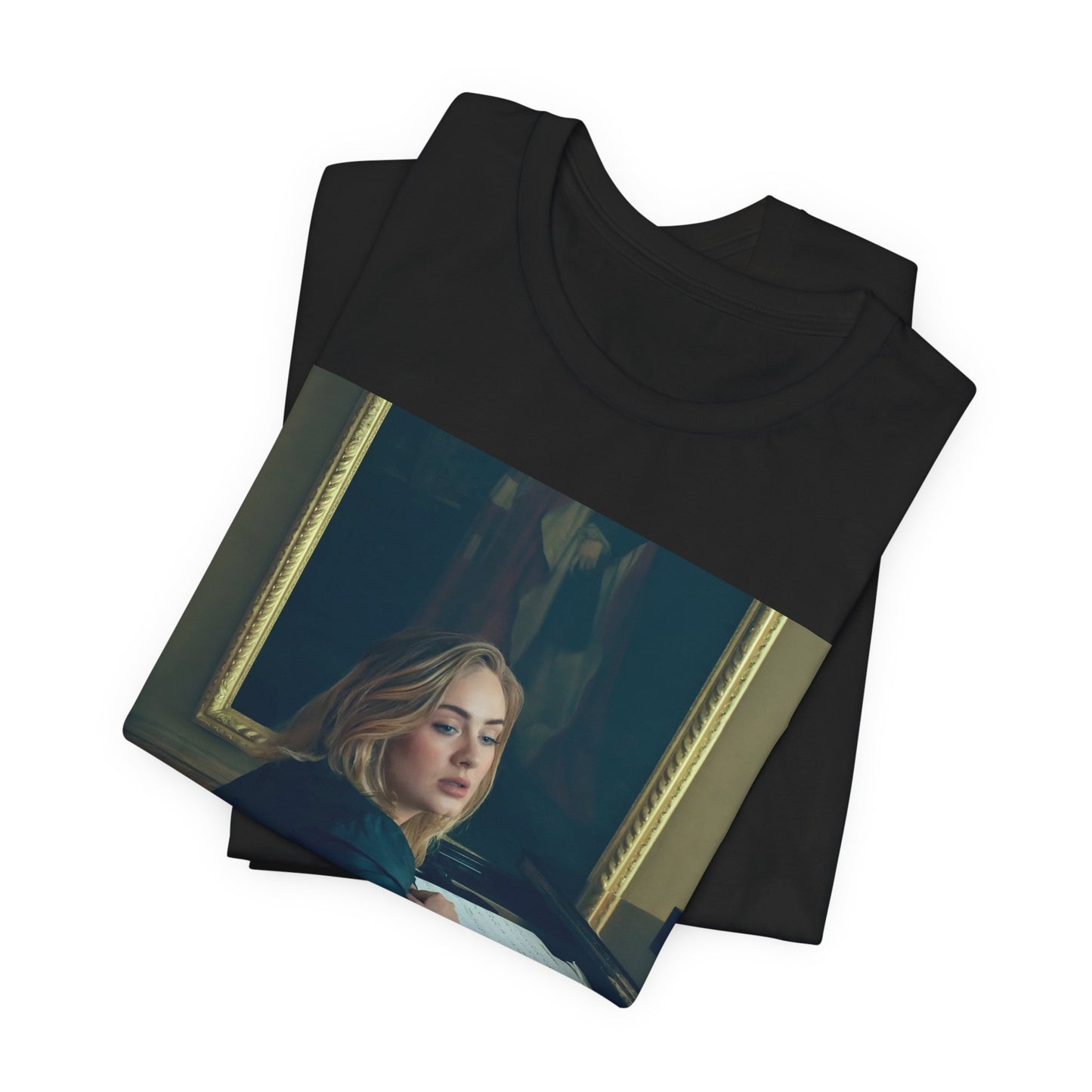 A black graphic t-shirt featuring a black and white photo of Adele sitting at a piano, with a focused and emotional expression as if performing.