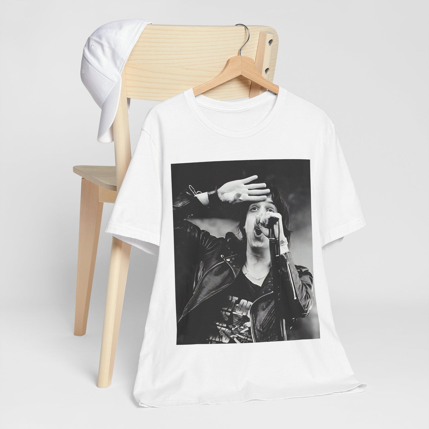 A black graphic t-shirt featuring a black and white portrait photo of The Strokes band.