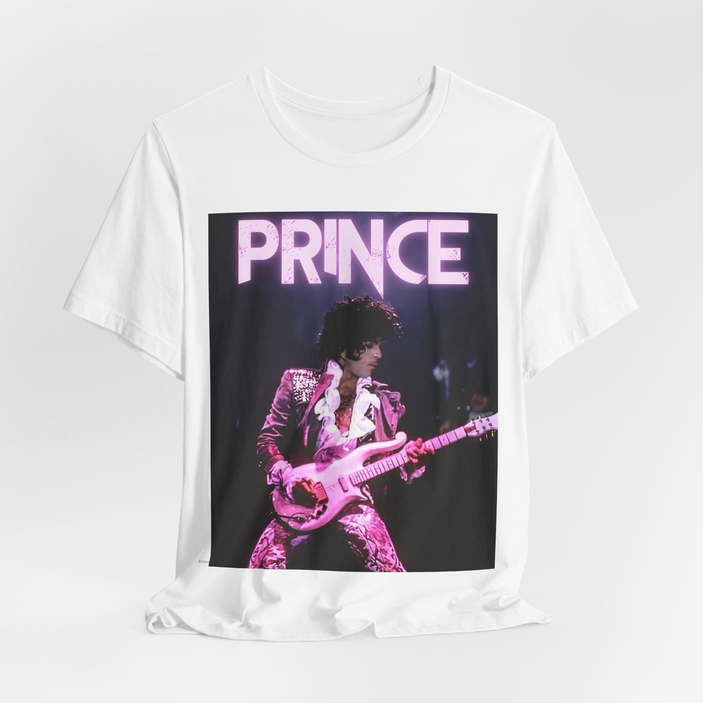 A black graphic t-shirt featuring an 80s pop genius graphic of Prince.